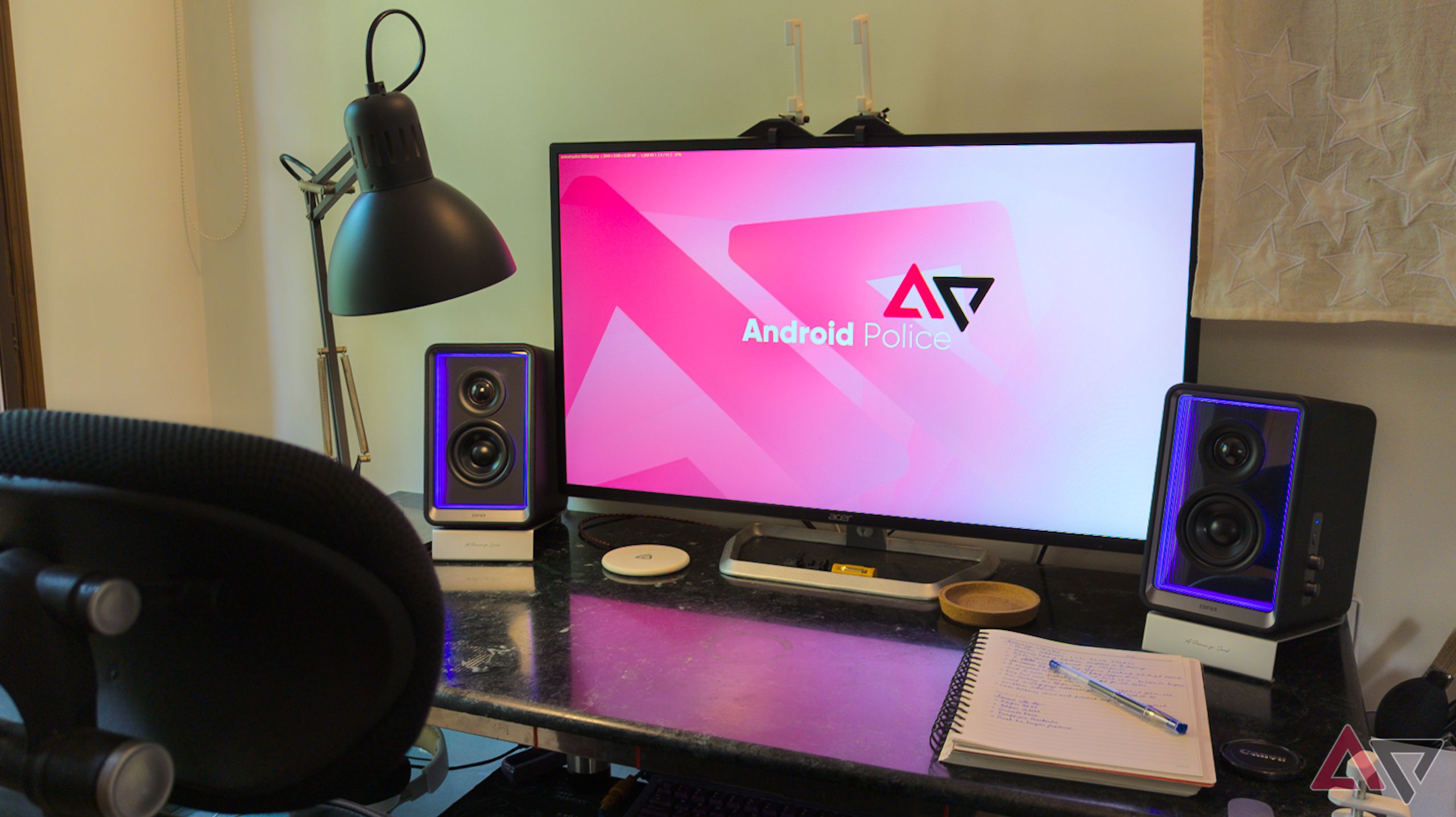 Angled speakers flanking a computer monitor