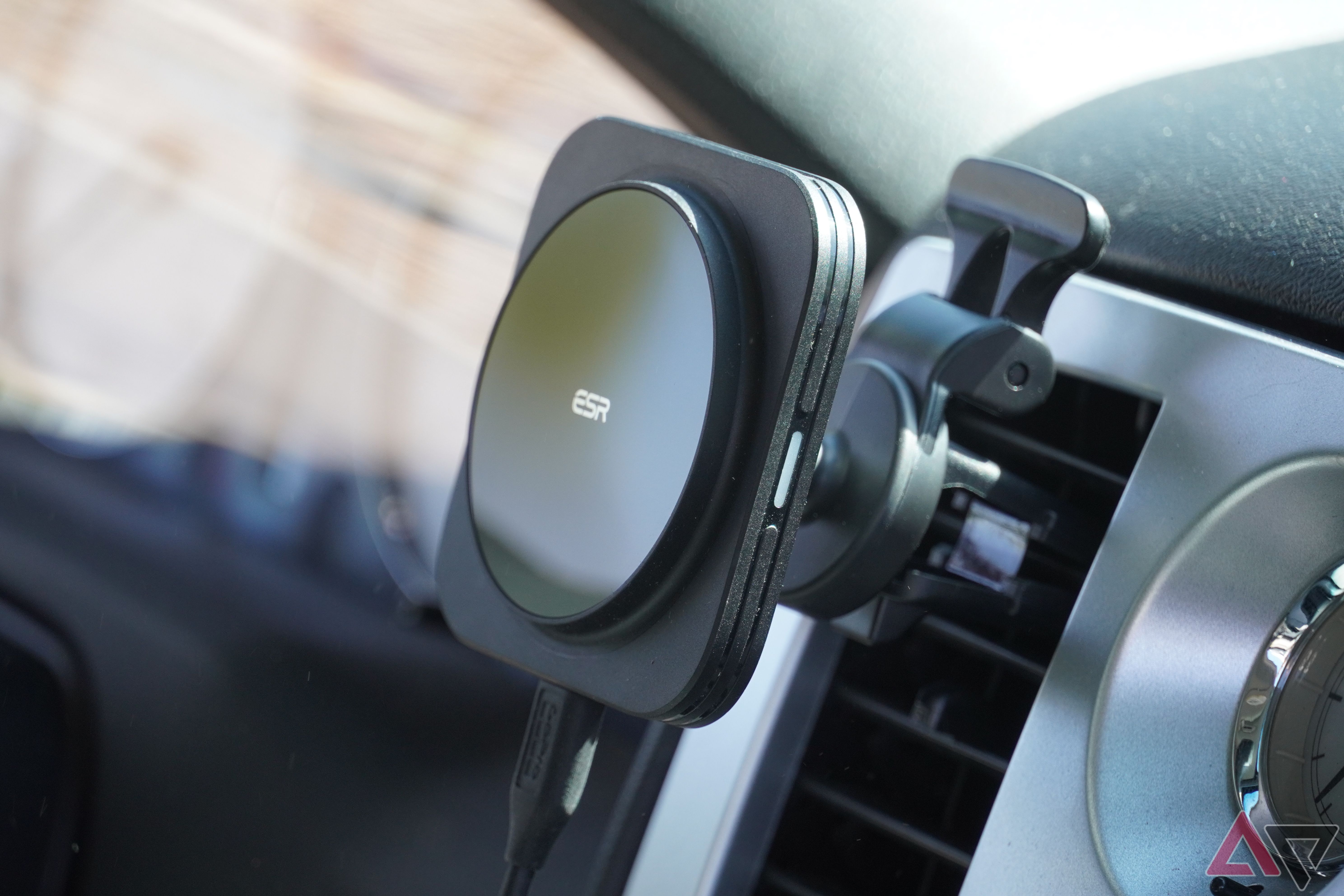 An angled view of the ESR Qi2 car charger mounted on air conditioning vents.