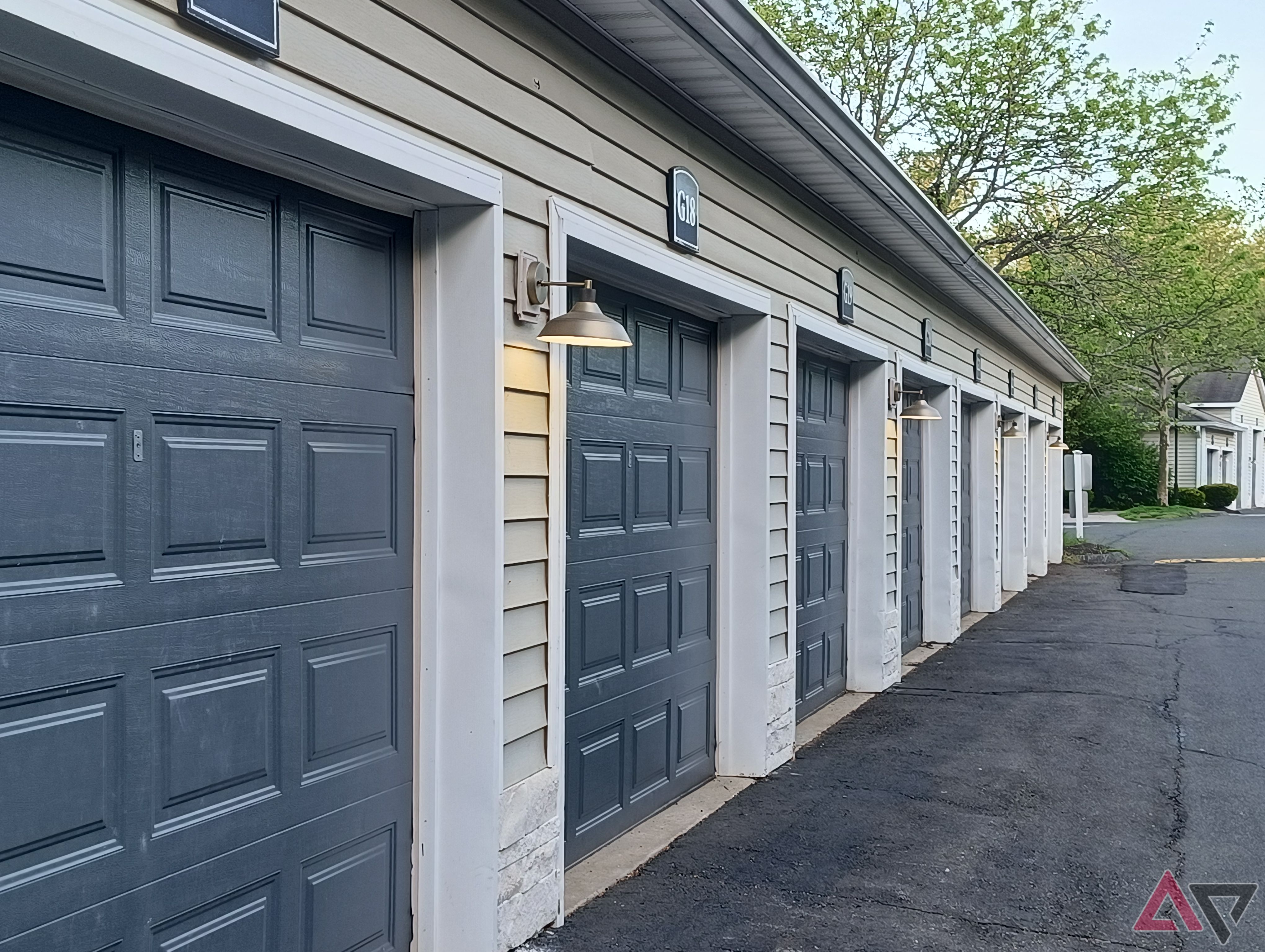 Image of a row of garage doors with their lights on