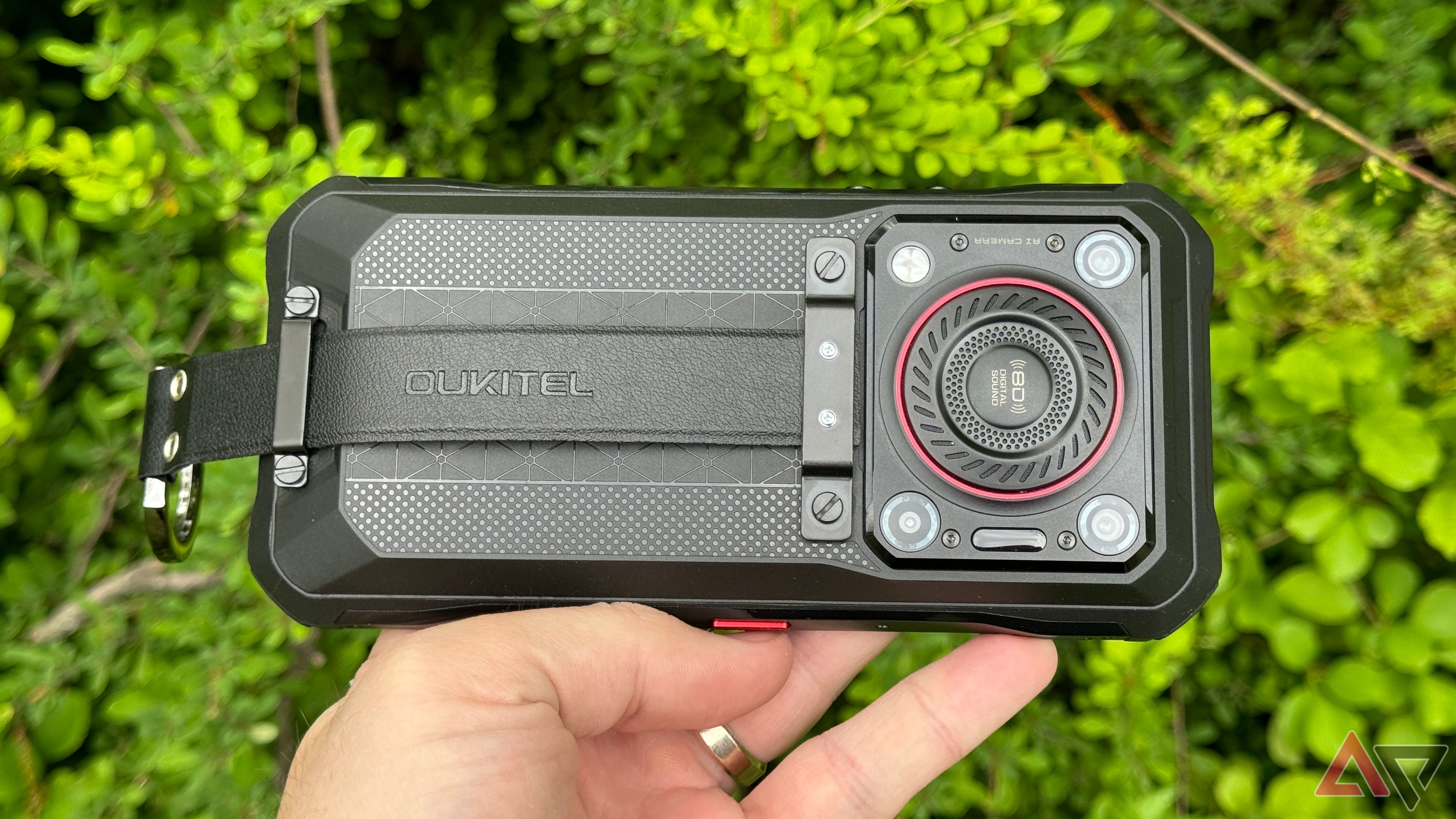 Oukitel WP33 Pro held sideways against a bush