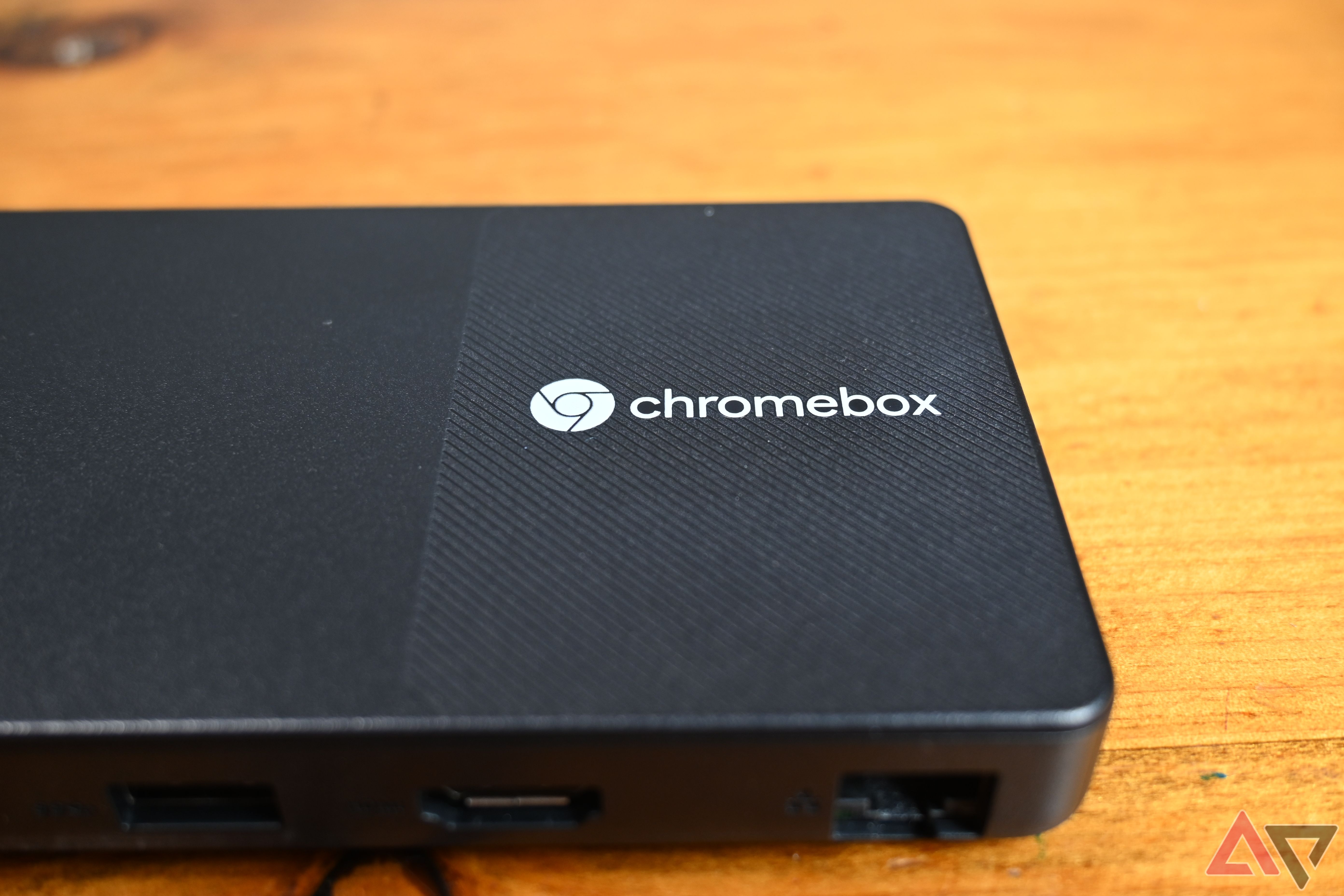 Lenovo Chromebox Micro on a light wooden table showing the Chromebox logo