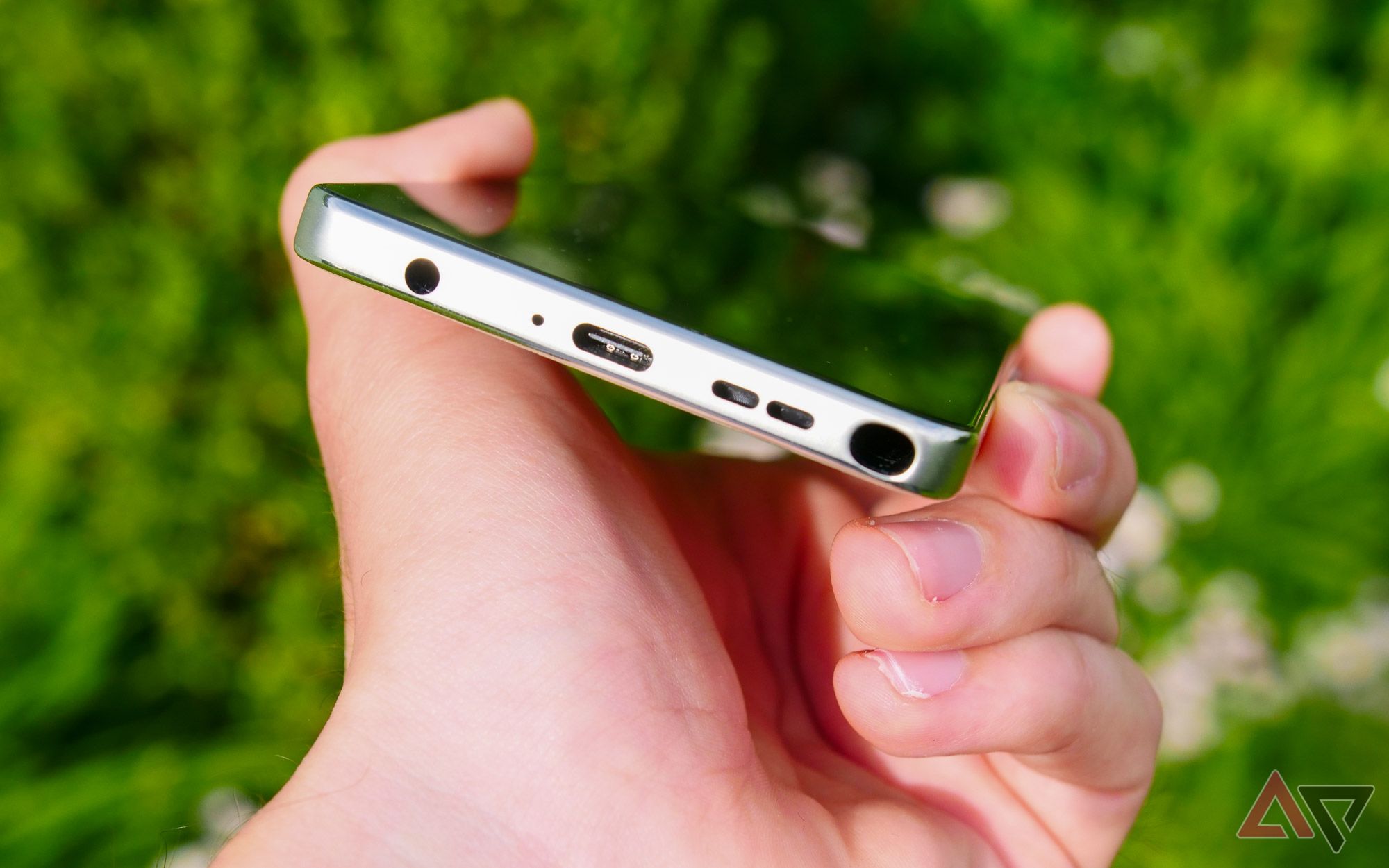 The Moto G Stylus held upside down showing off the plastic silver frame.