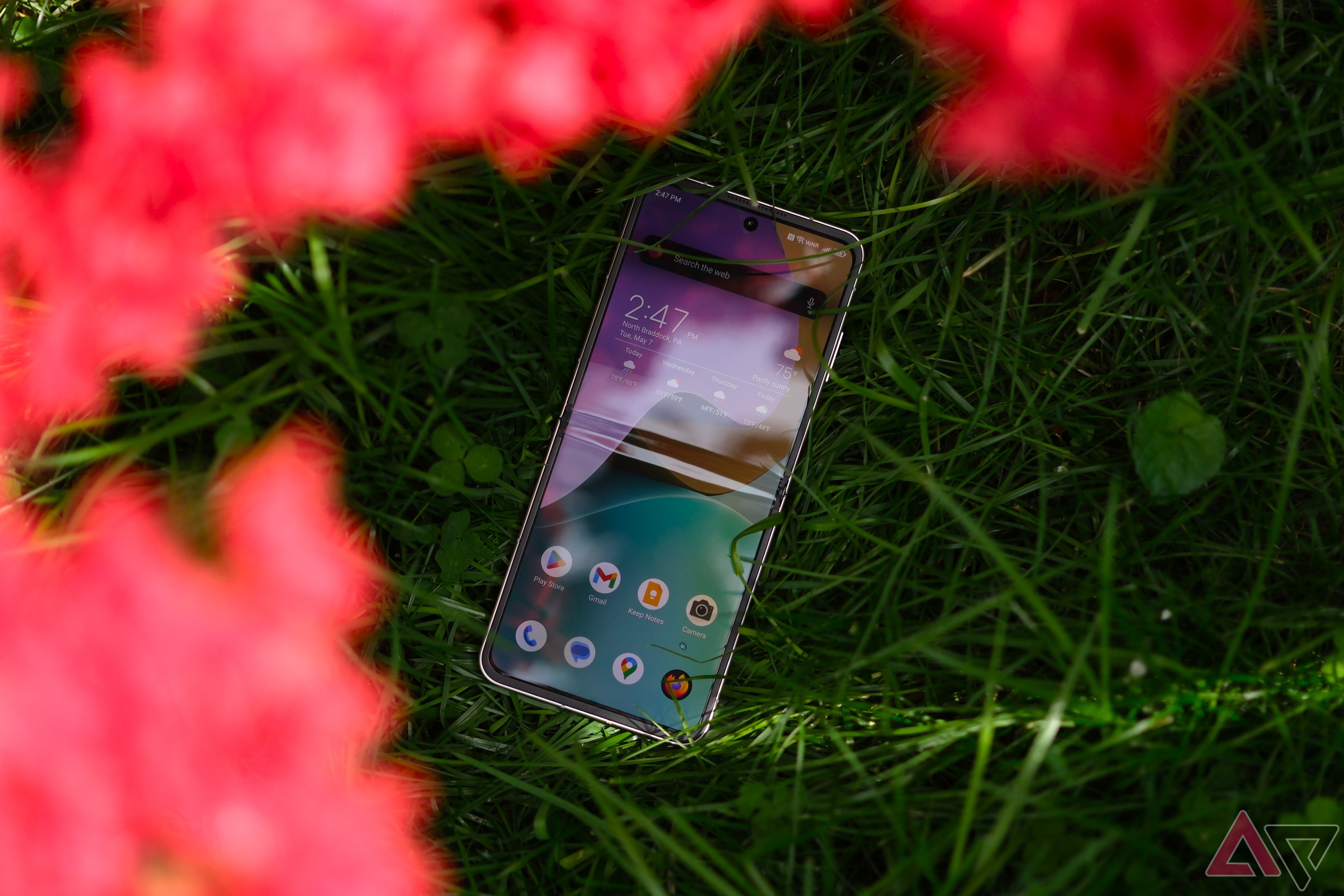 Nubia Flip 5G laying in bed of grass unfolded with screen facing up