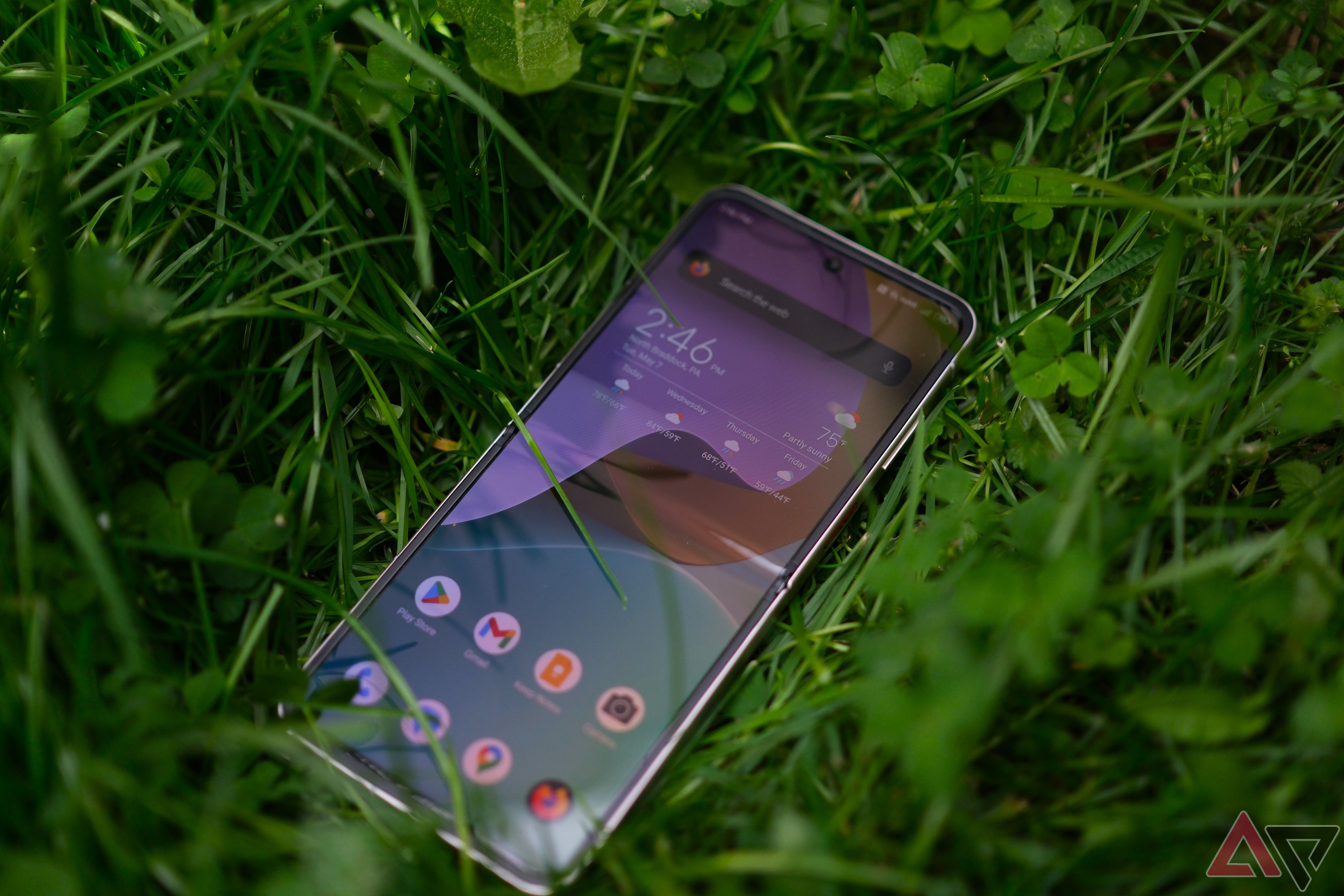 Nubia Flip 5G laying open on a bed of grass with screen on