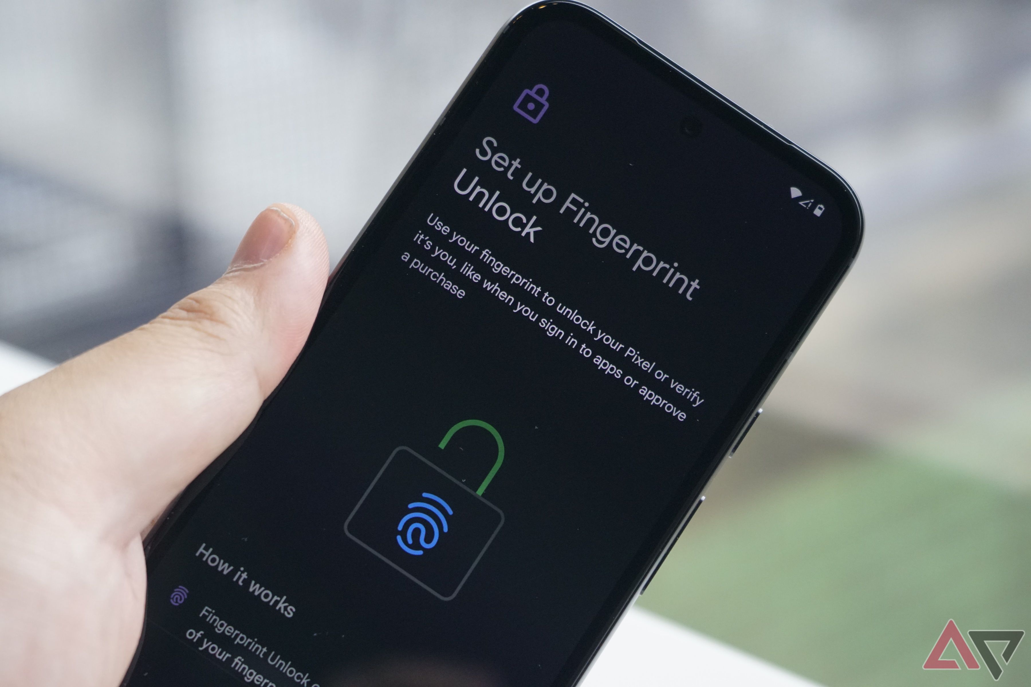 A Pixel 8a being held while setting up Fingerprint Unlock