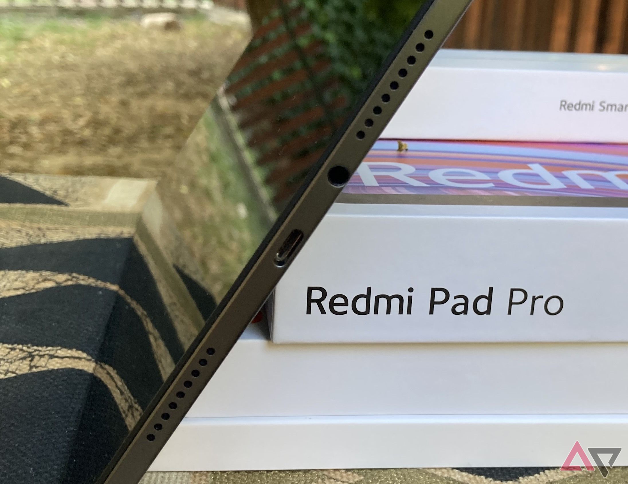 A picture of the Redmi Pad Pro's USB port, headphone jack, and two right-side speakers
