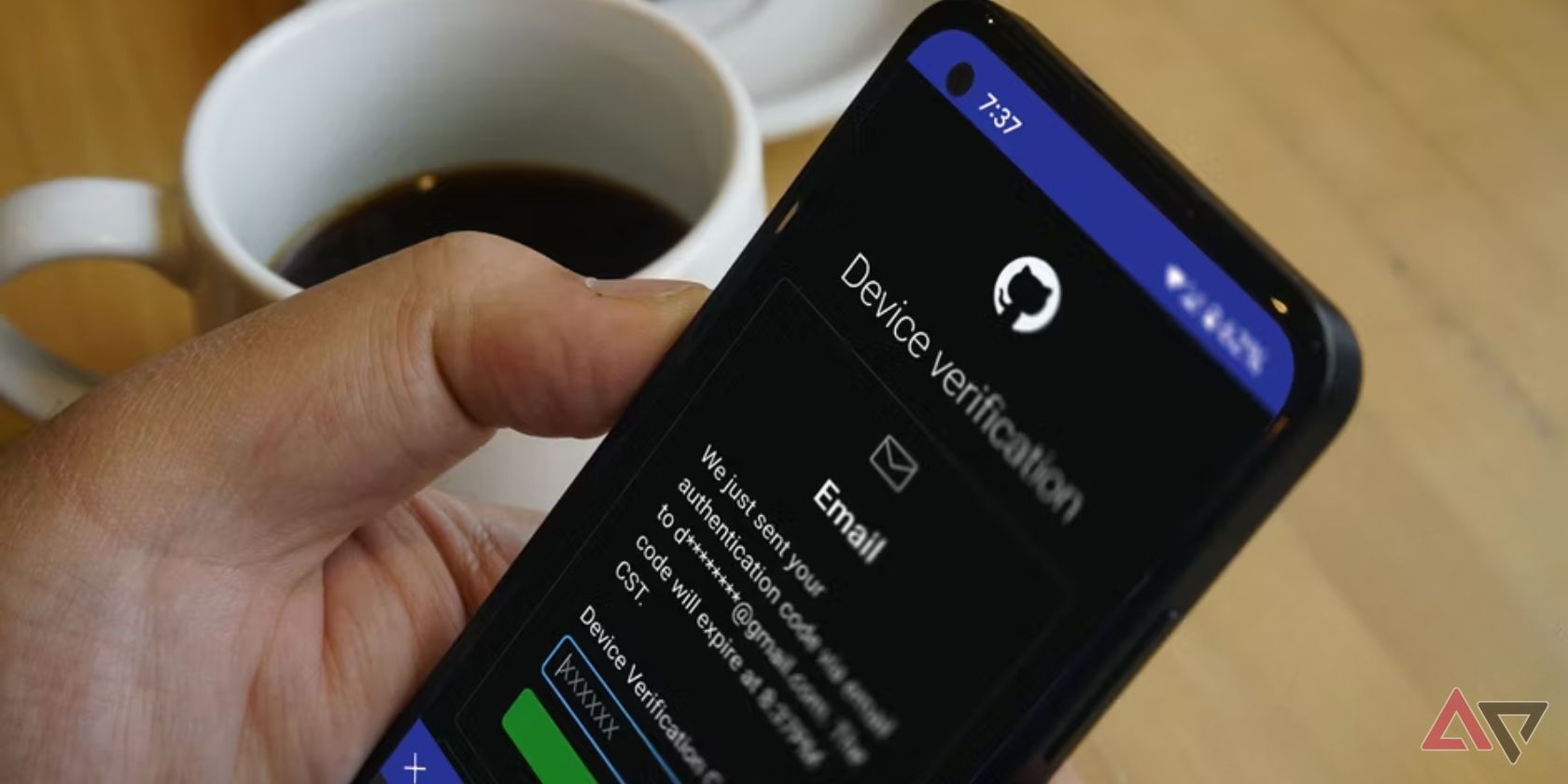 hand holding android phone with device verification notification