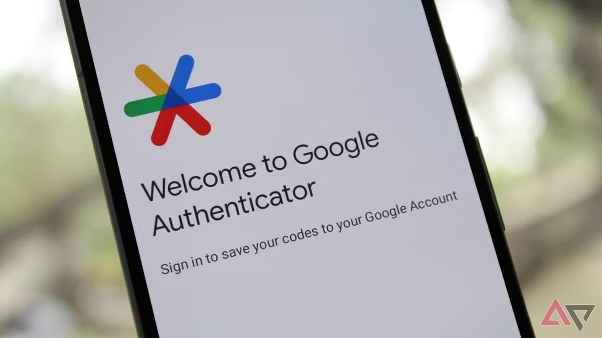 A phone with the message 'Welcome to Google Authenticator' on the screen 