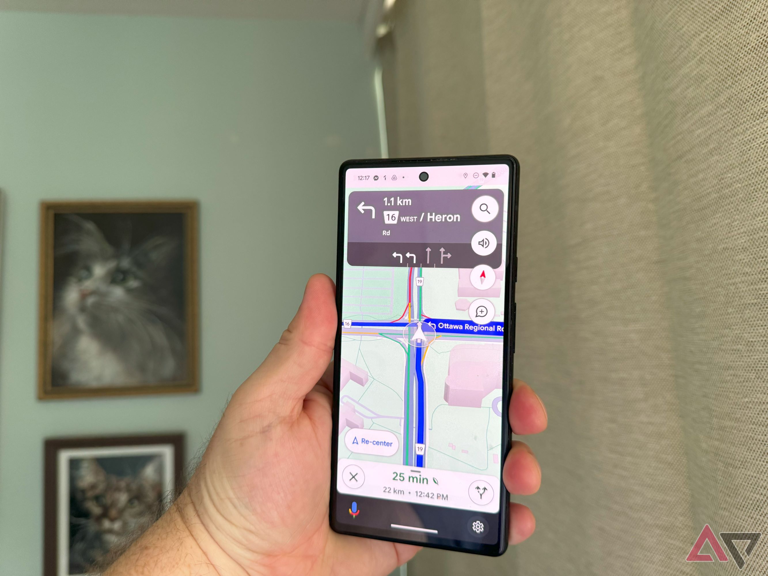 A hand holding a Pixel 6 with Google Maps open showing its lane assist function.
