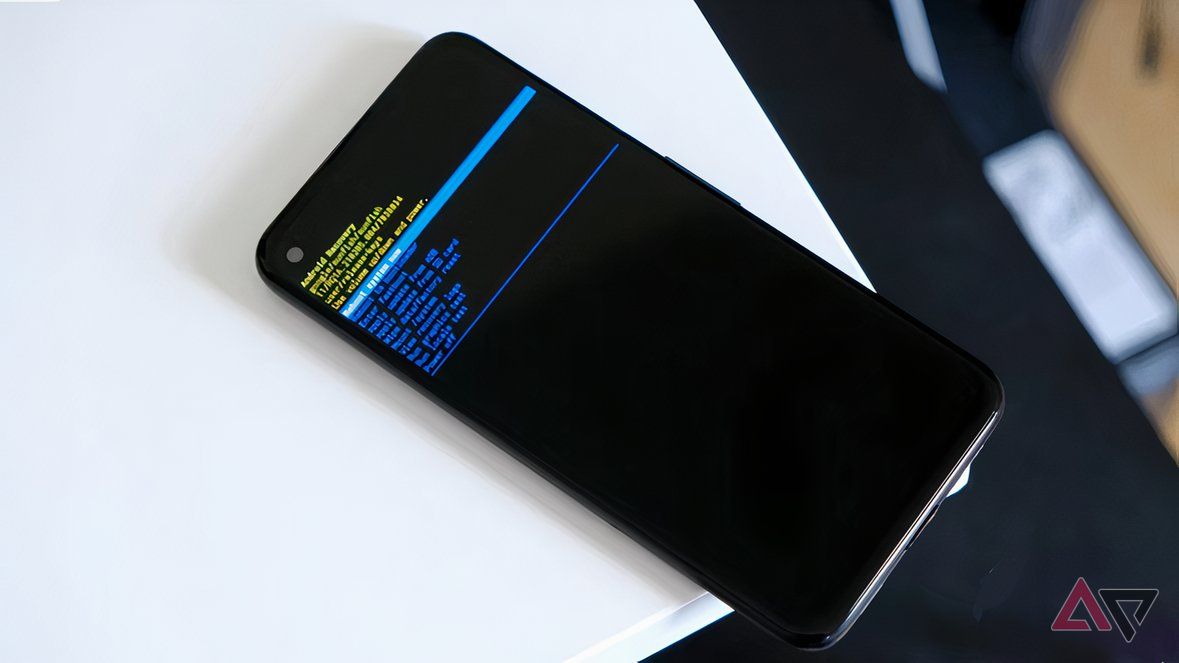 A phone in Android Recovery Mode atop a white table.