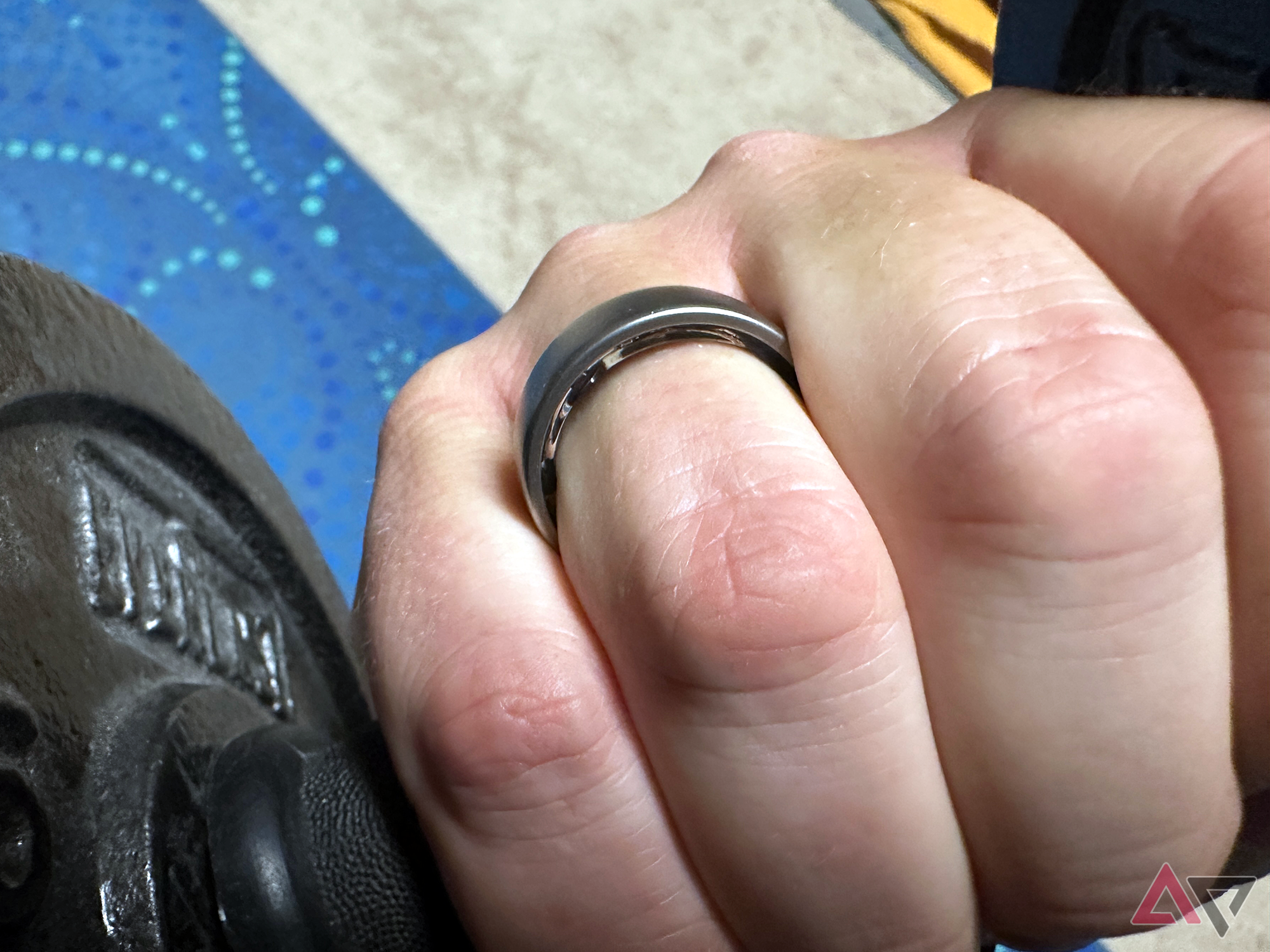 Amazfit Helio Smart Ring on hand with dumbell