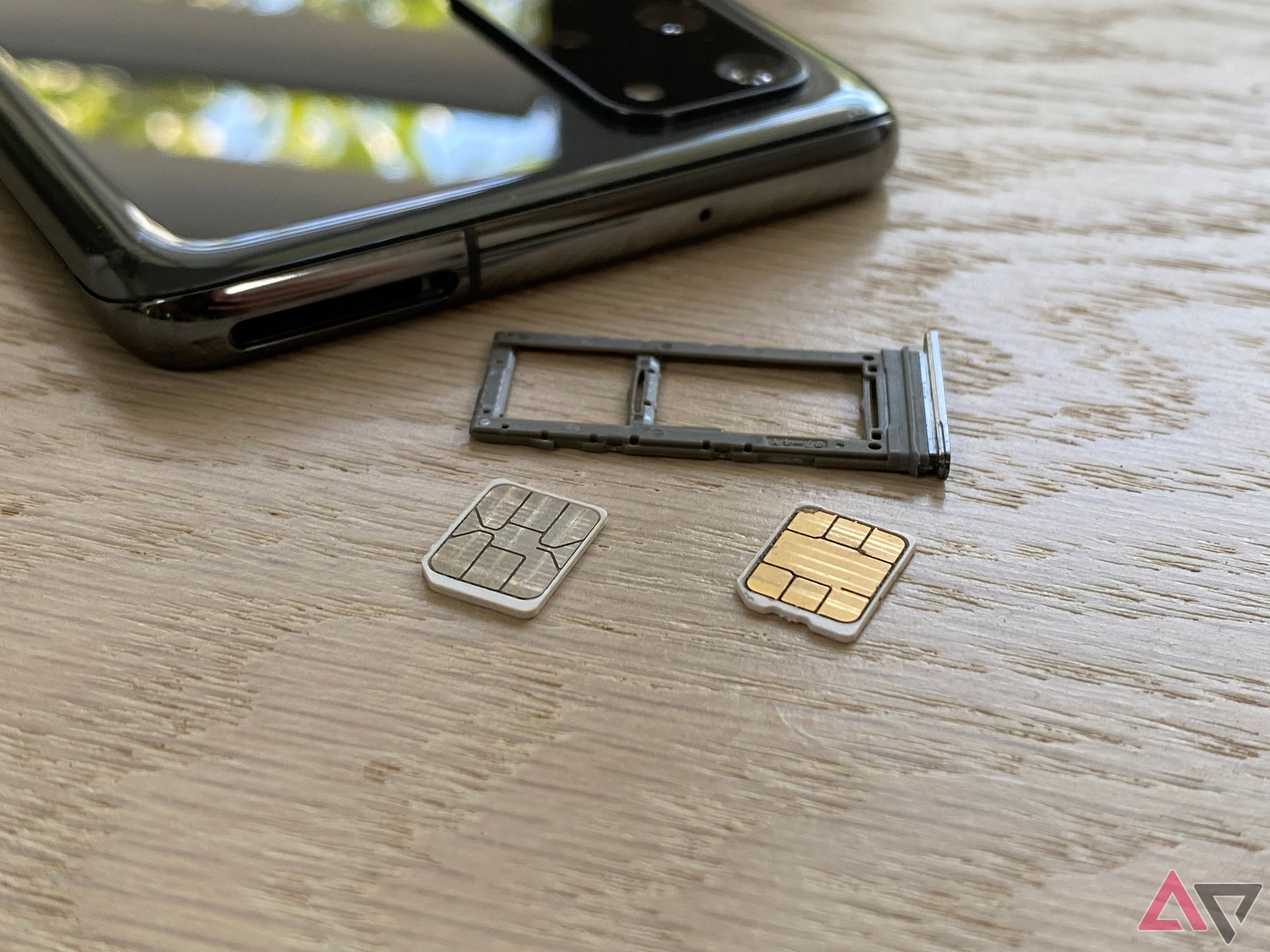 SIM cards next to a phone an tray