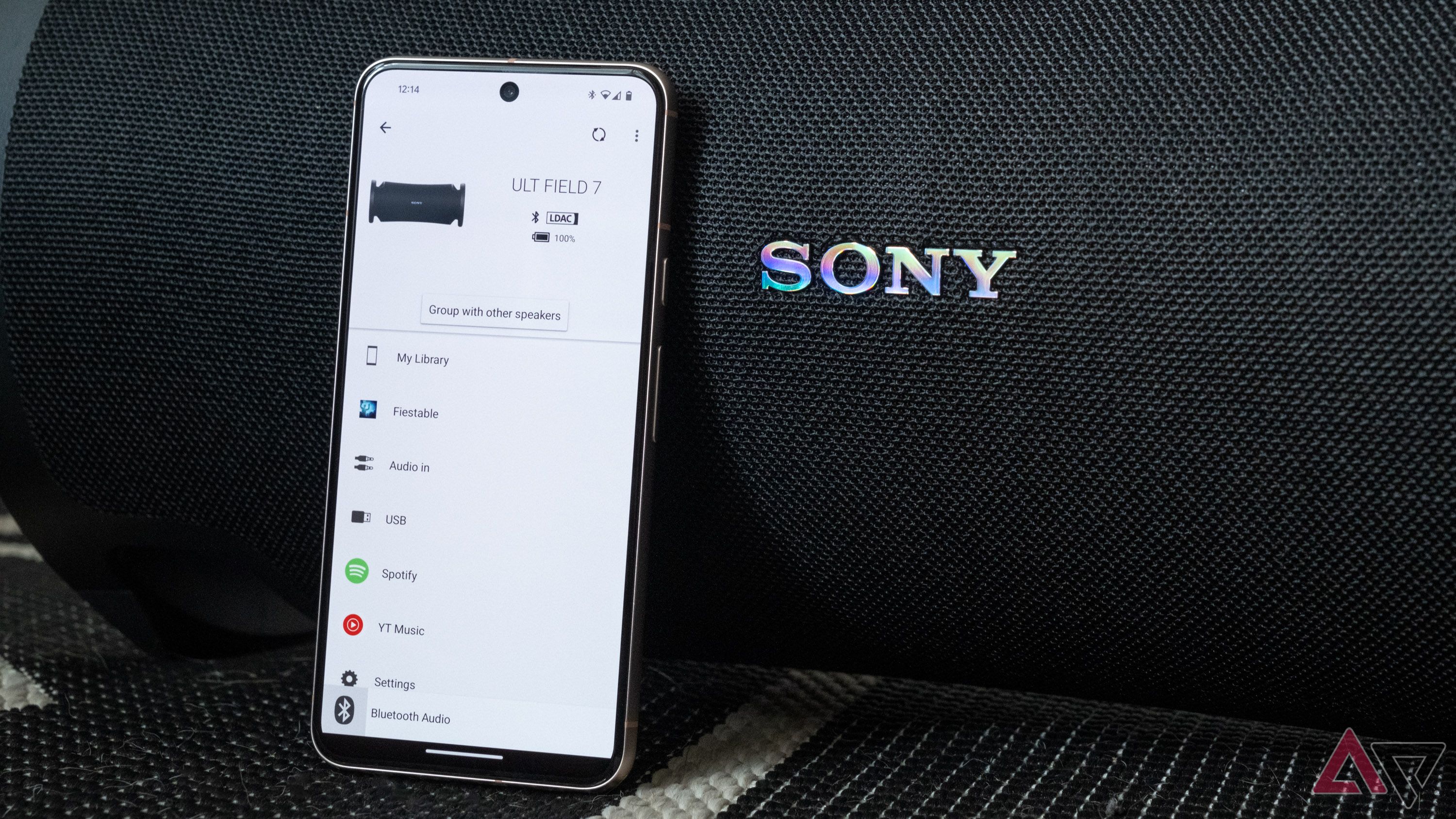 Sony's companion app on a phone leaning against a Sony speaker