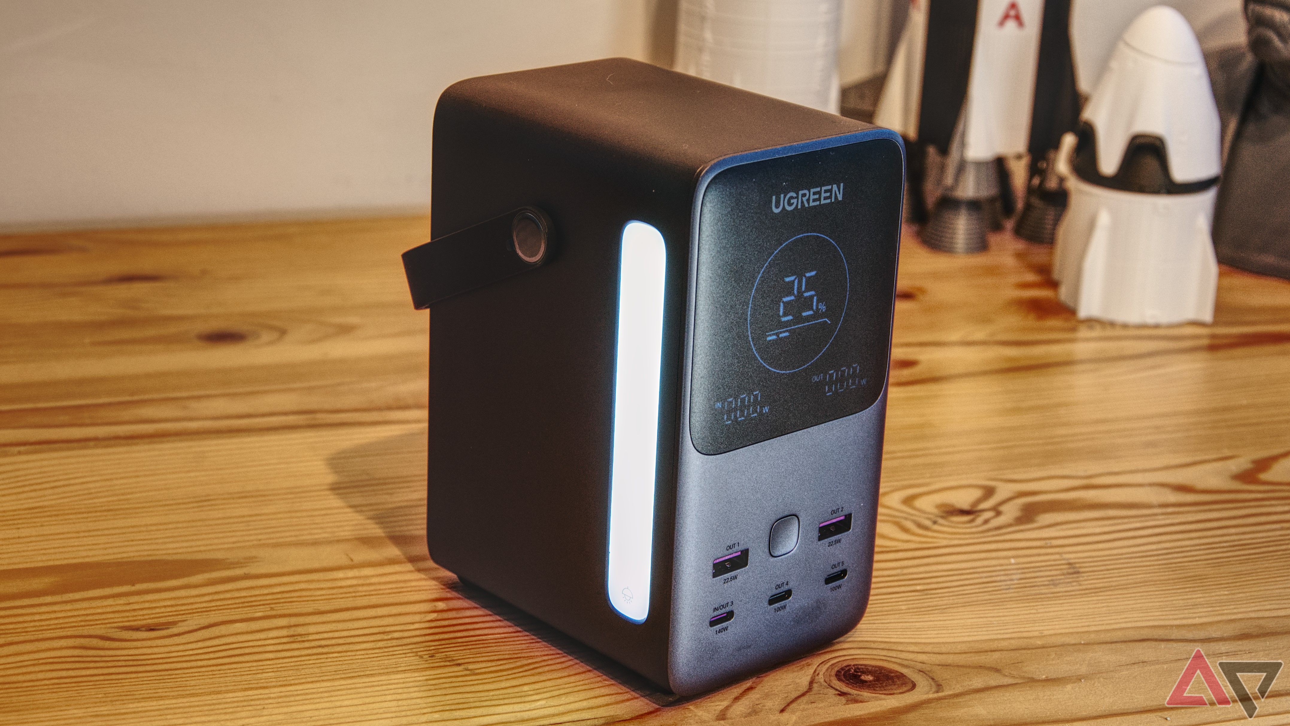 Ugreen power bank on a table with display and light showing