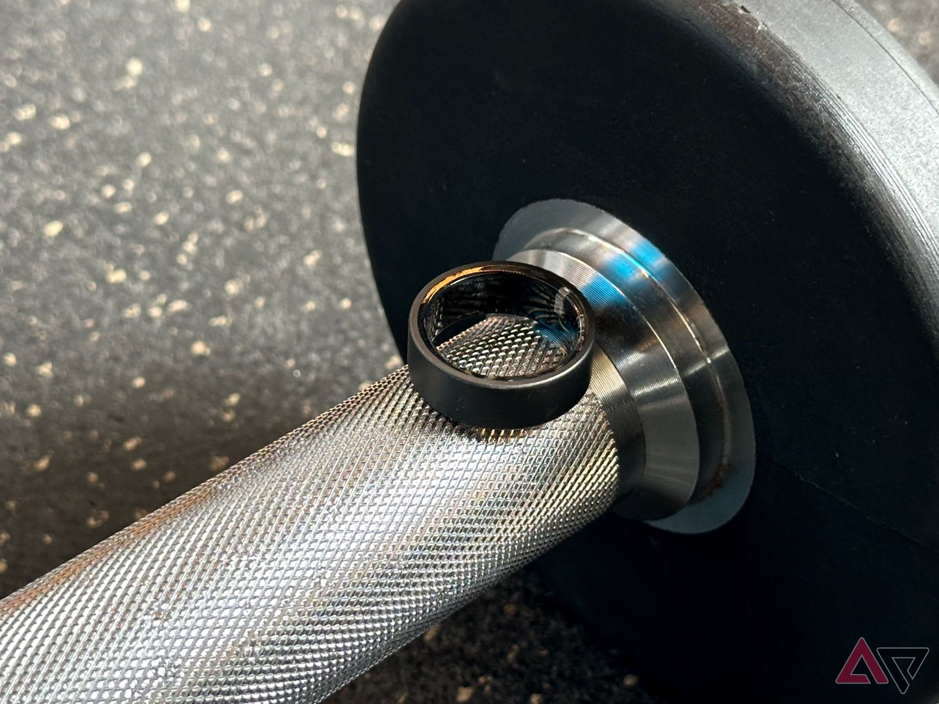 ultrahuman ring air smart ring on a dumbbell in gym