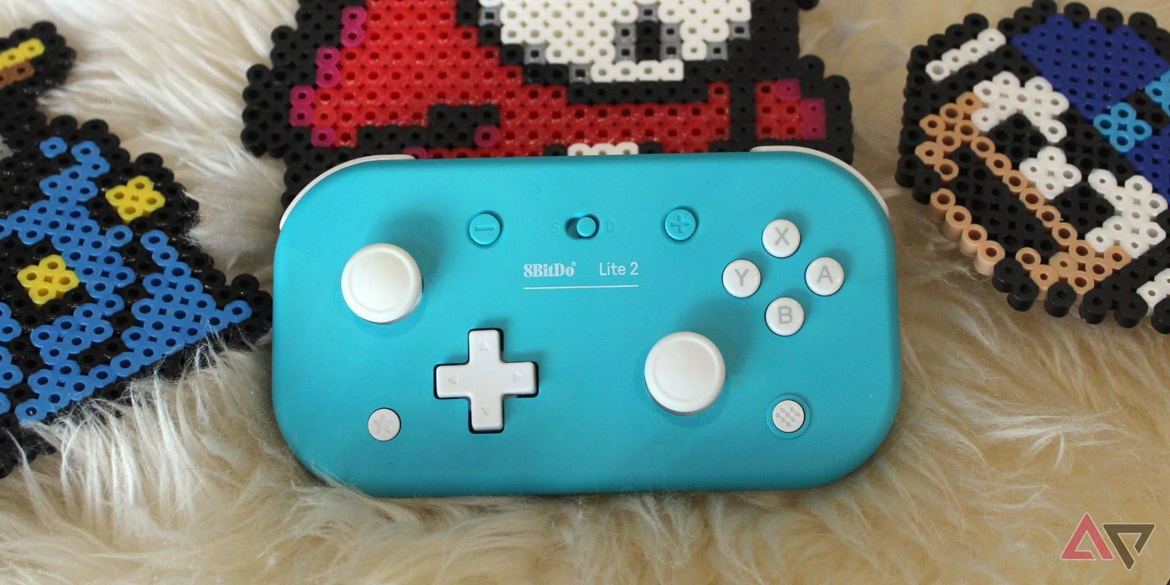 blue and white controller on white fur rug