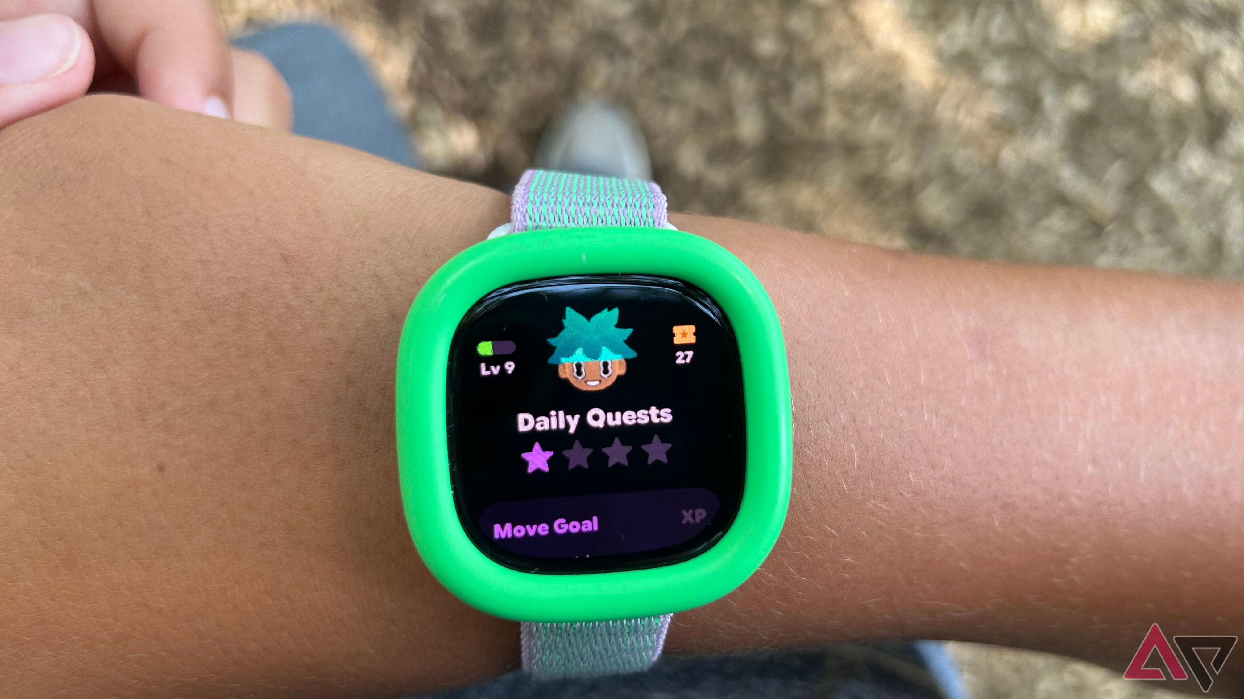 Fitbit Ace LTE on wrist with screen showing Daily Quests