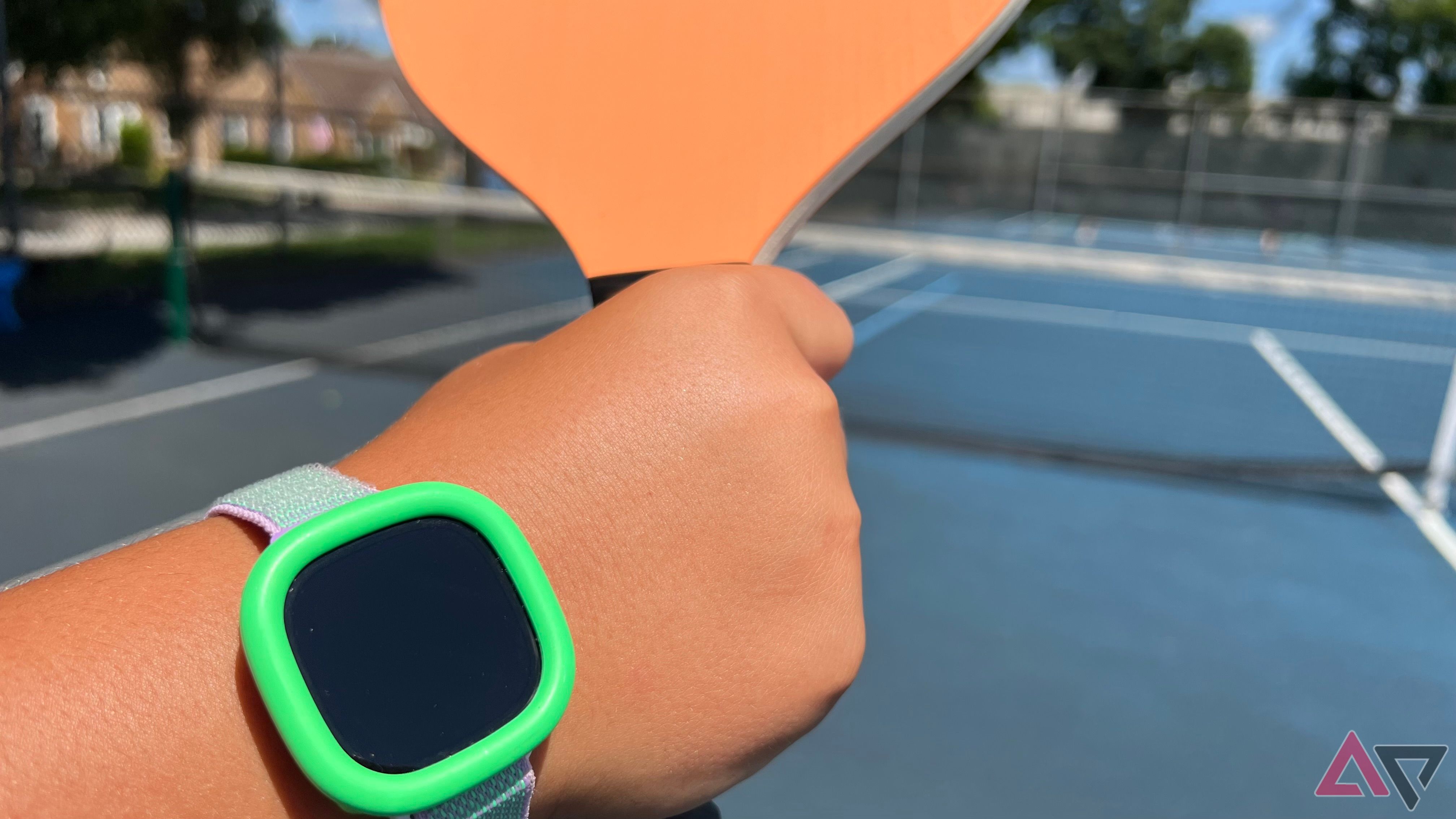 Person wearing Fitbit Ace LTE while playing pickle ball