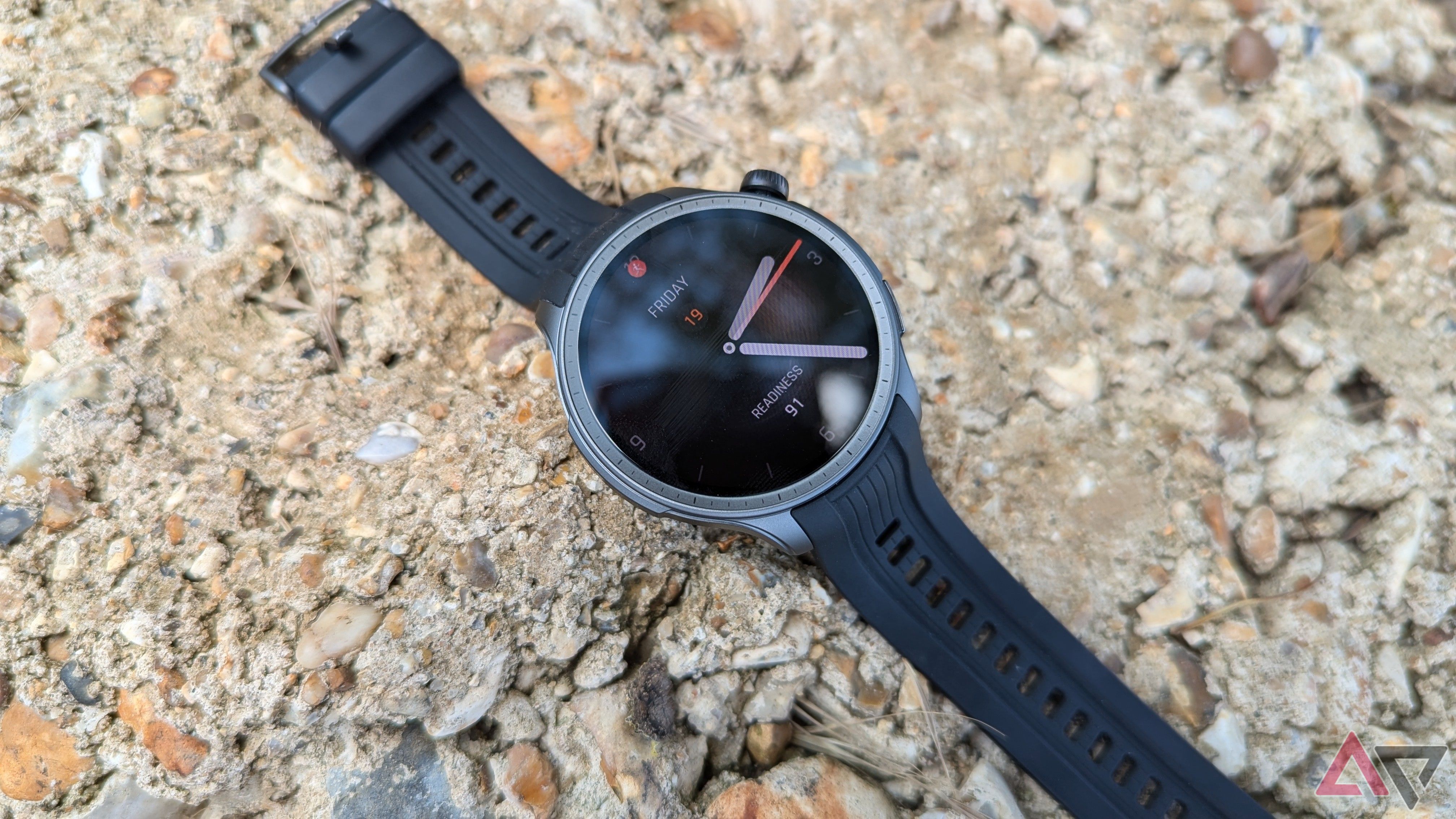 Amazfit Balance smartwatch in Midnight color placed on rocky surface