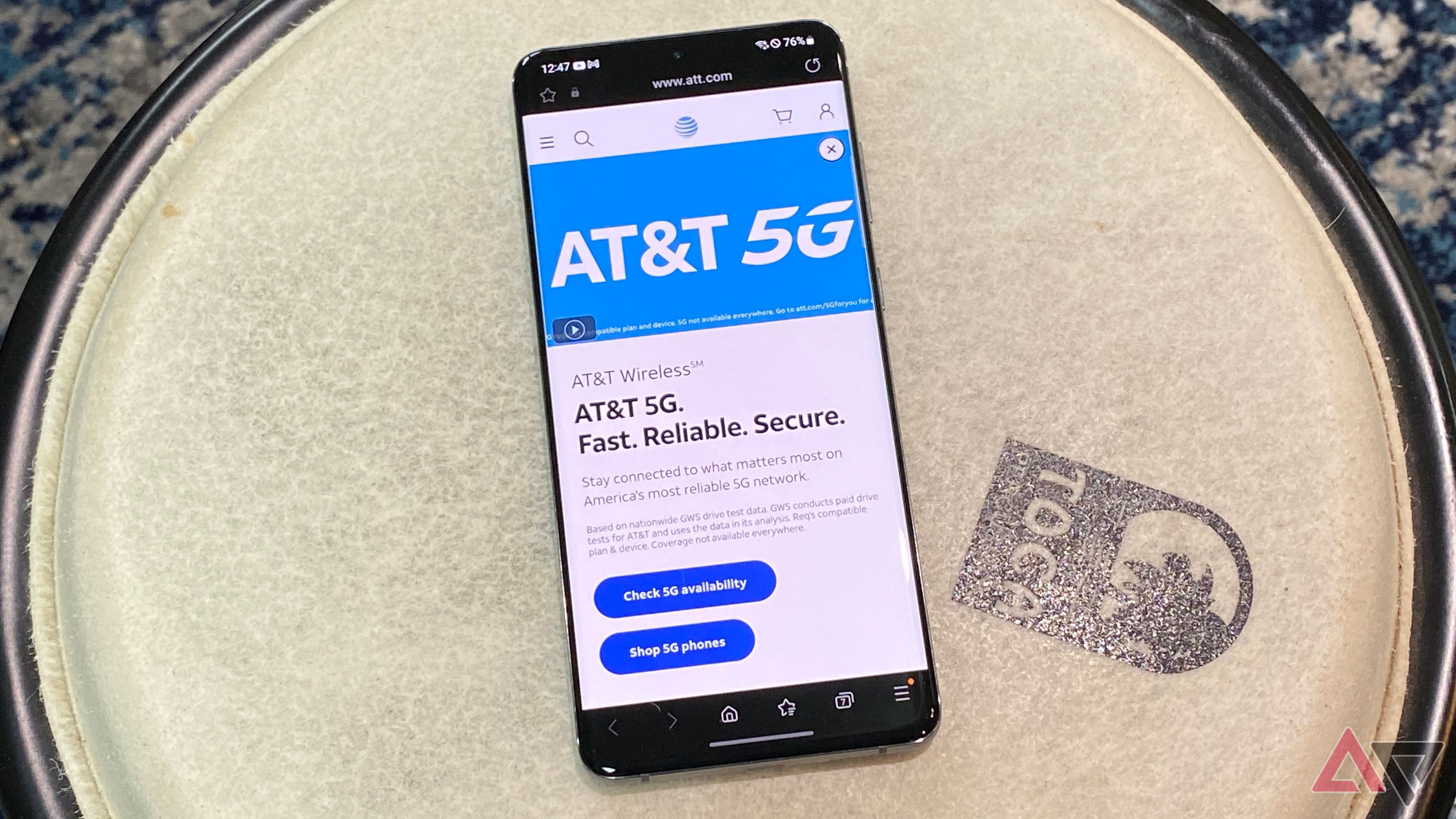 Android phone resting on drum with screen on AT&T website