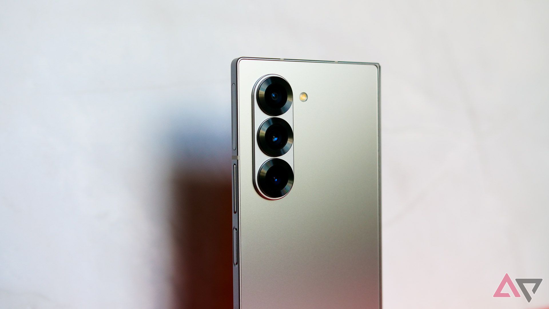 A close up on the Galaxy Z Fold 6's camera lenses with the phone casting a shadow in the background.