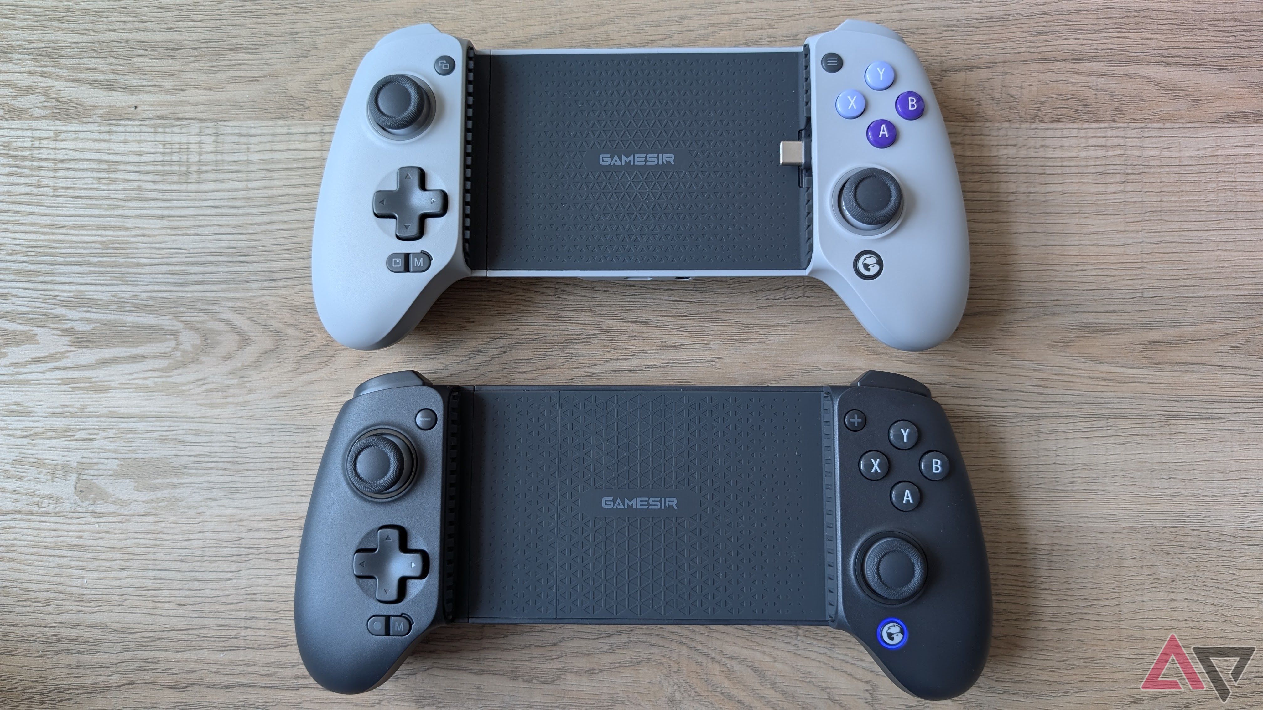 grey controller next to black controller