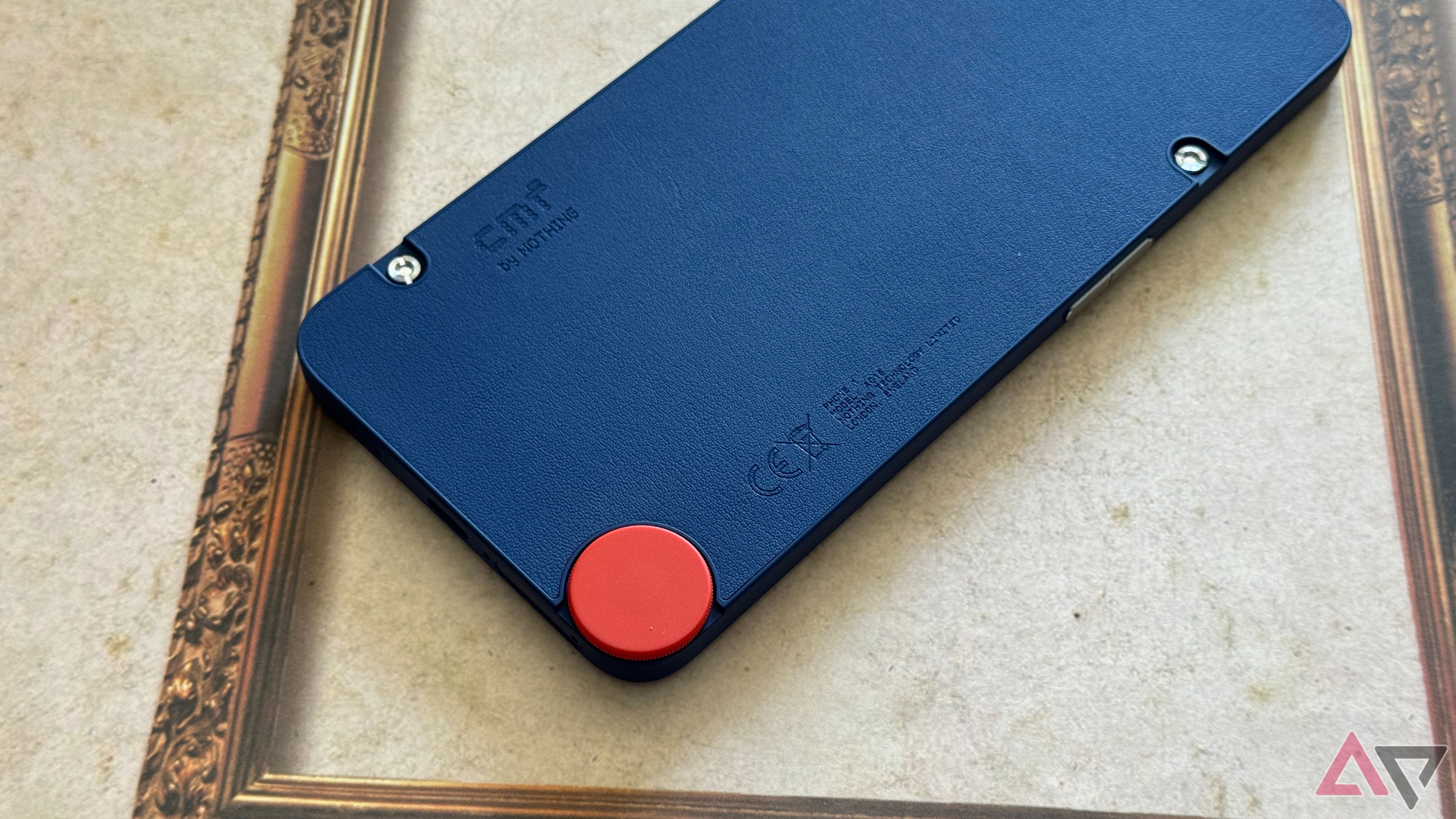 CMF Phone 1 with a blue case and mixed orange accessory screw