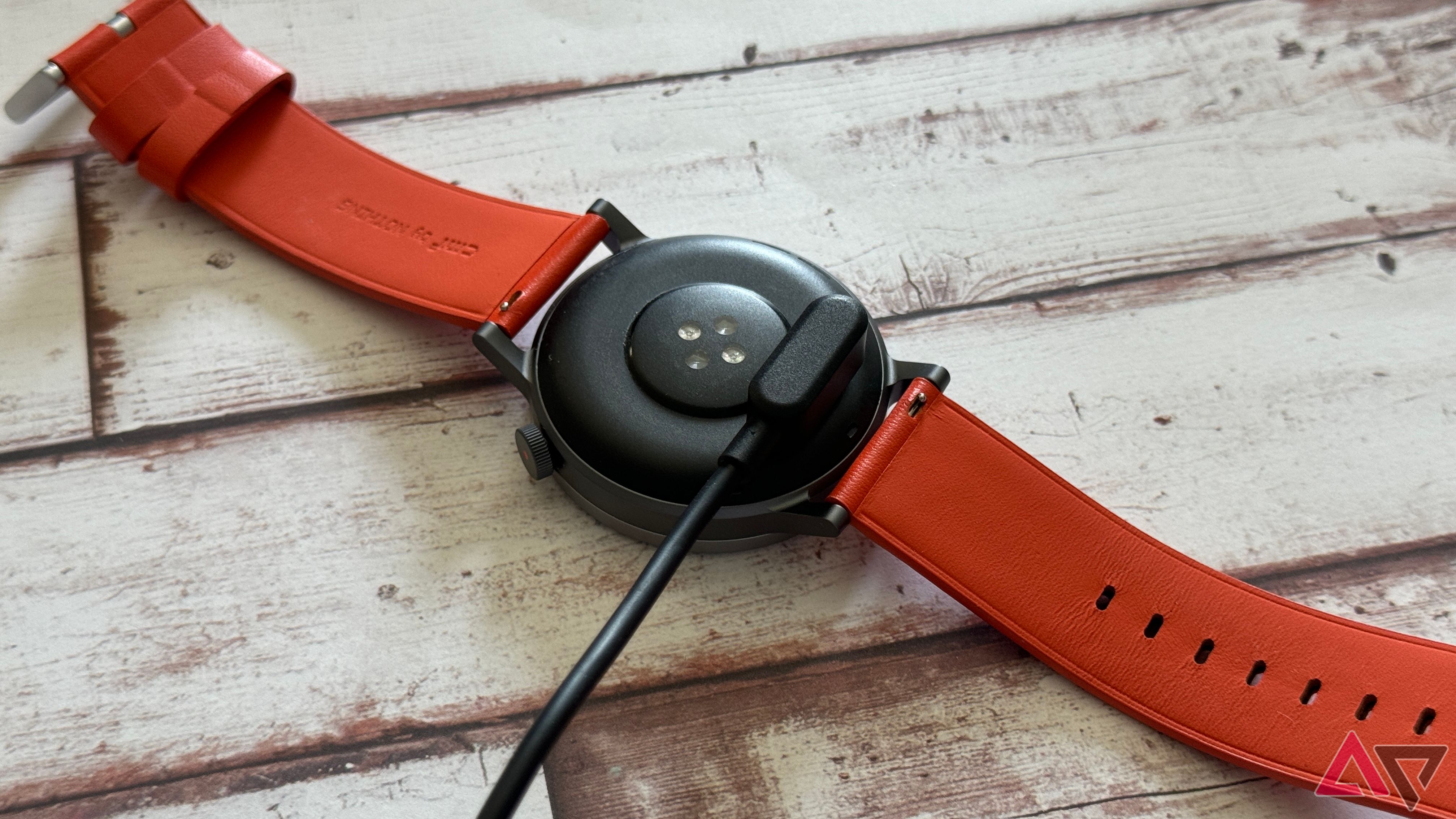 CMF Watch Pro 2 connected to its magnetic charging cable