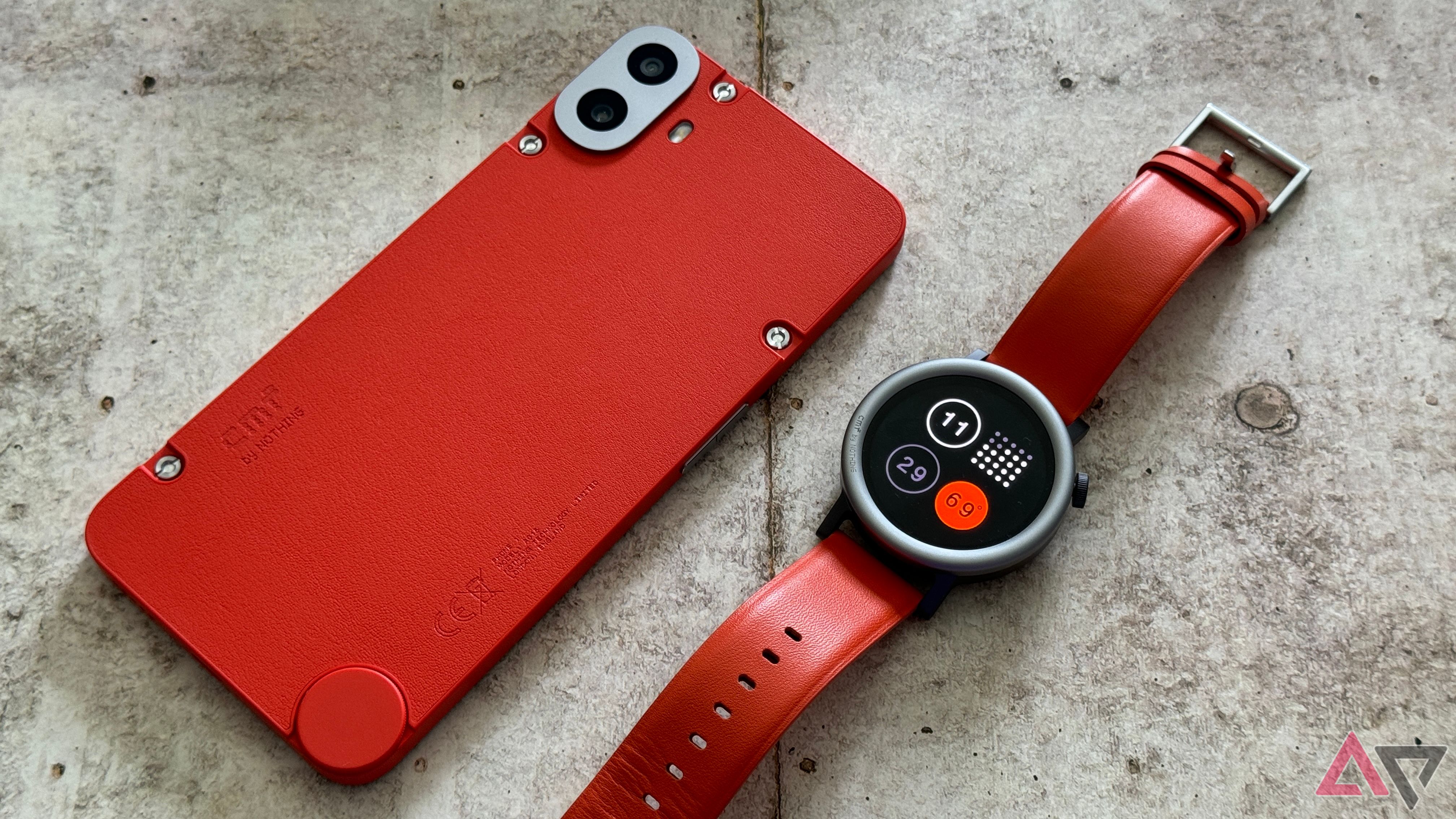 CMF Watch Pro 2 in orange sitting next to the CMF Phone 1, also in orange