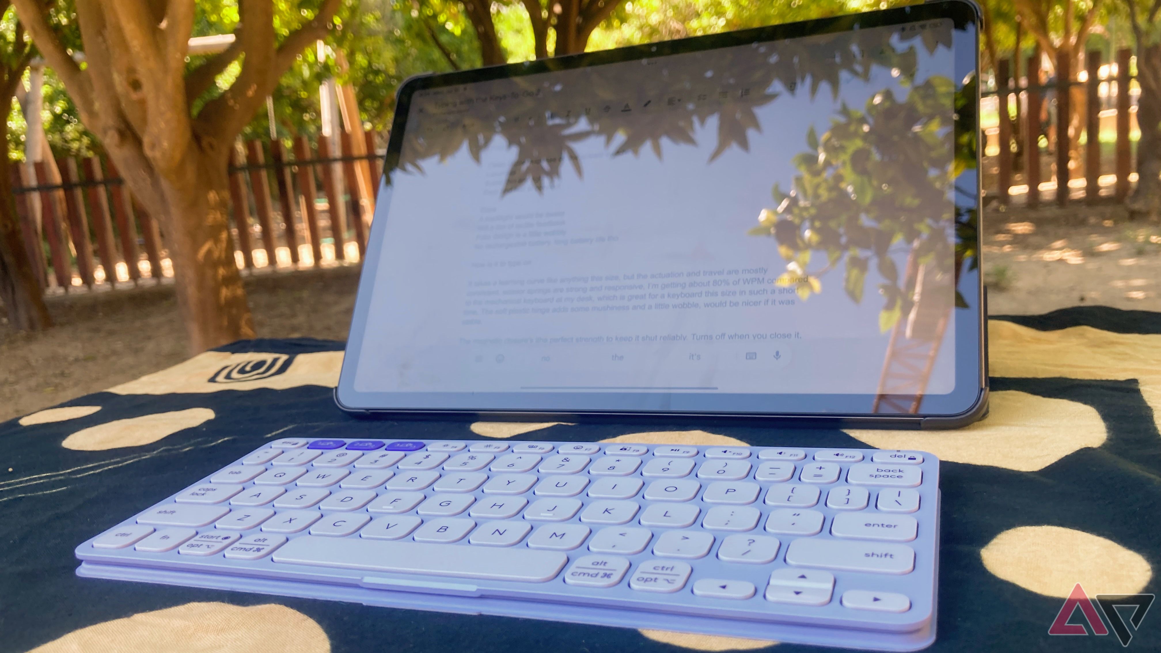 The Logitech Keys-To-Go 2 with the Redmi Pad Pro on a park table