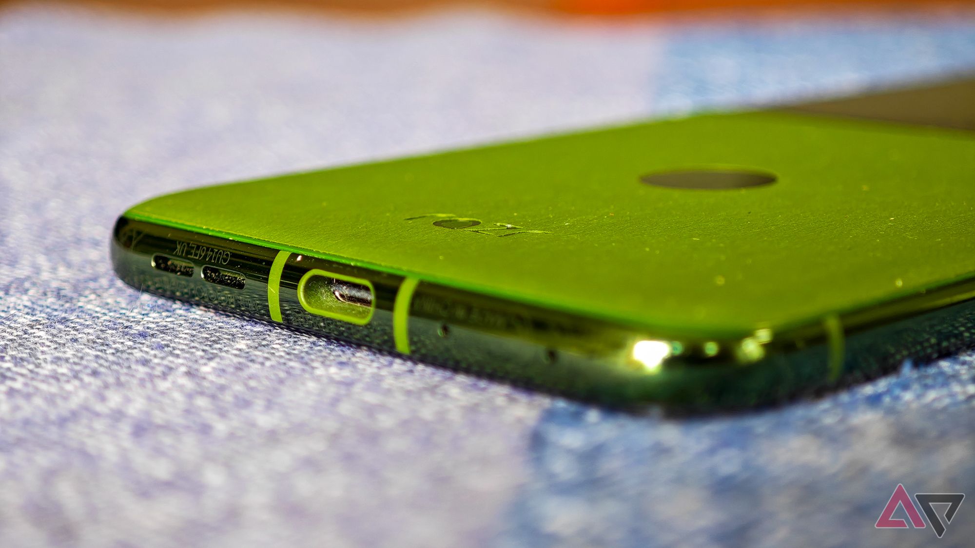 Motorola Razr+ 2024 resting on a blue tablecloth with a close-up on the USB-C port