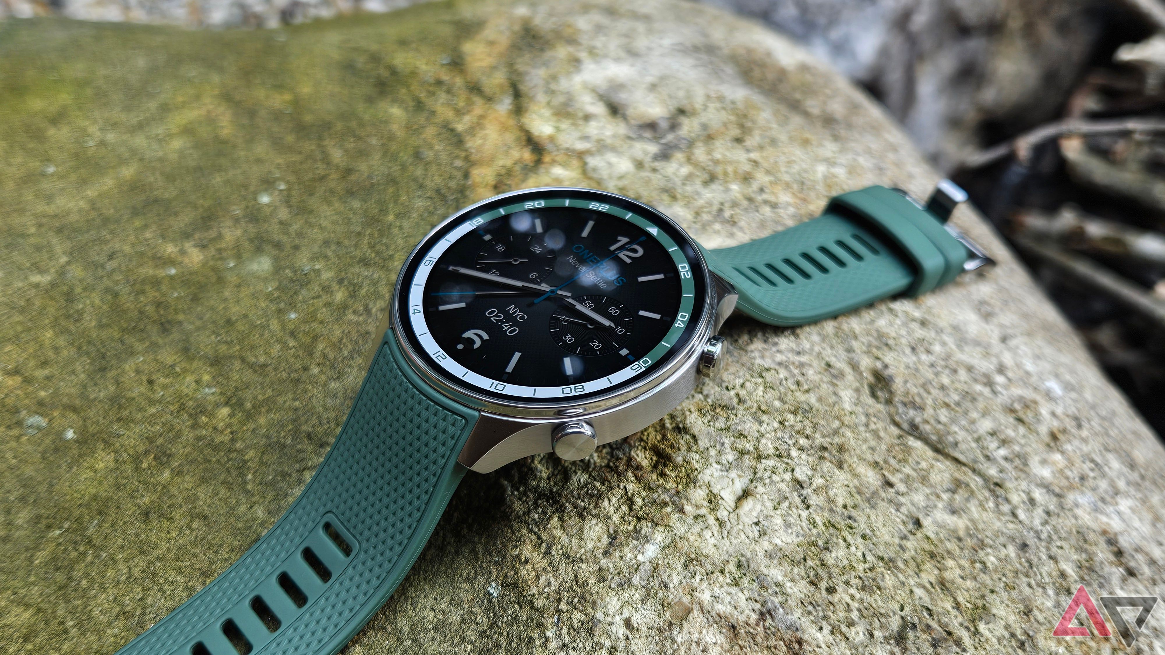 OnePlus Watch 2R on a gray rock in Forest Green