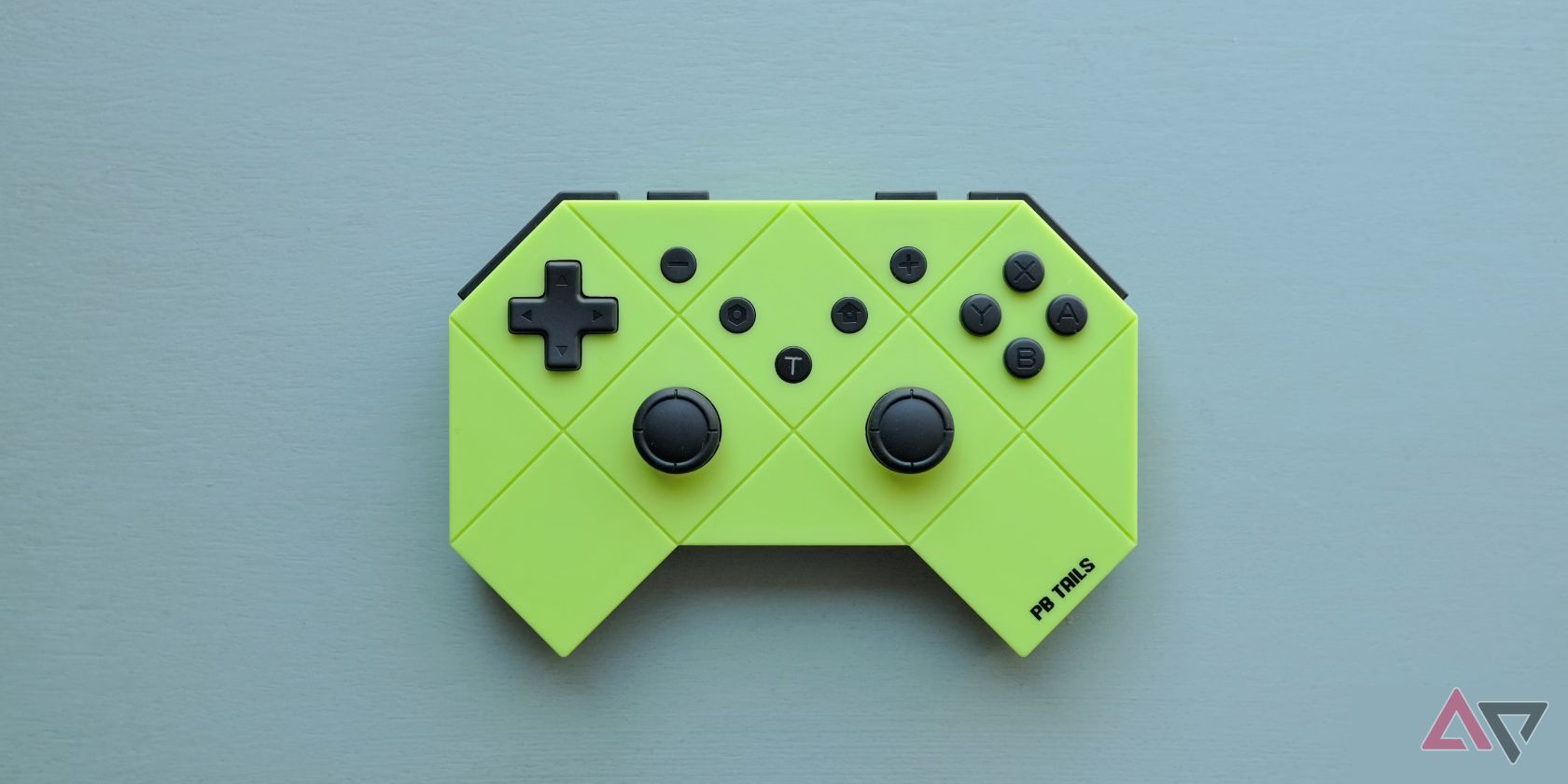 green game controller on blue background