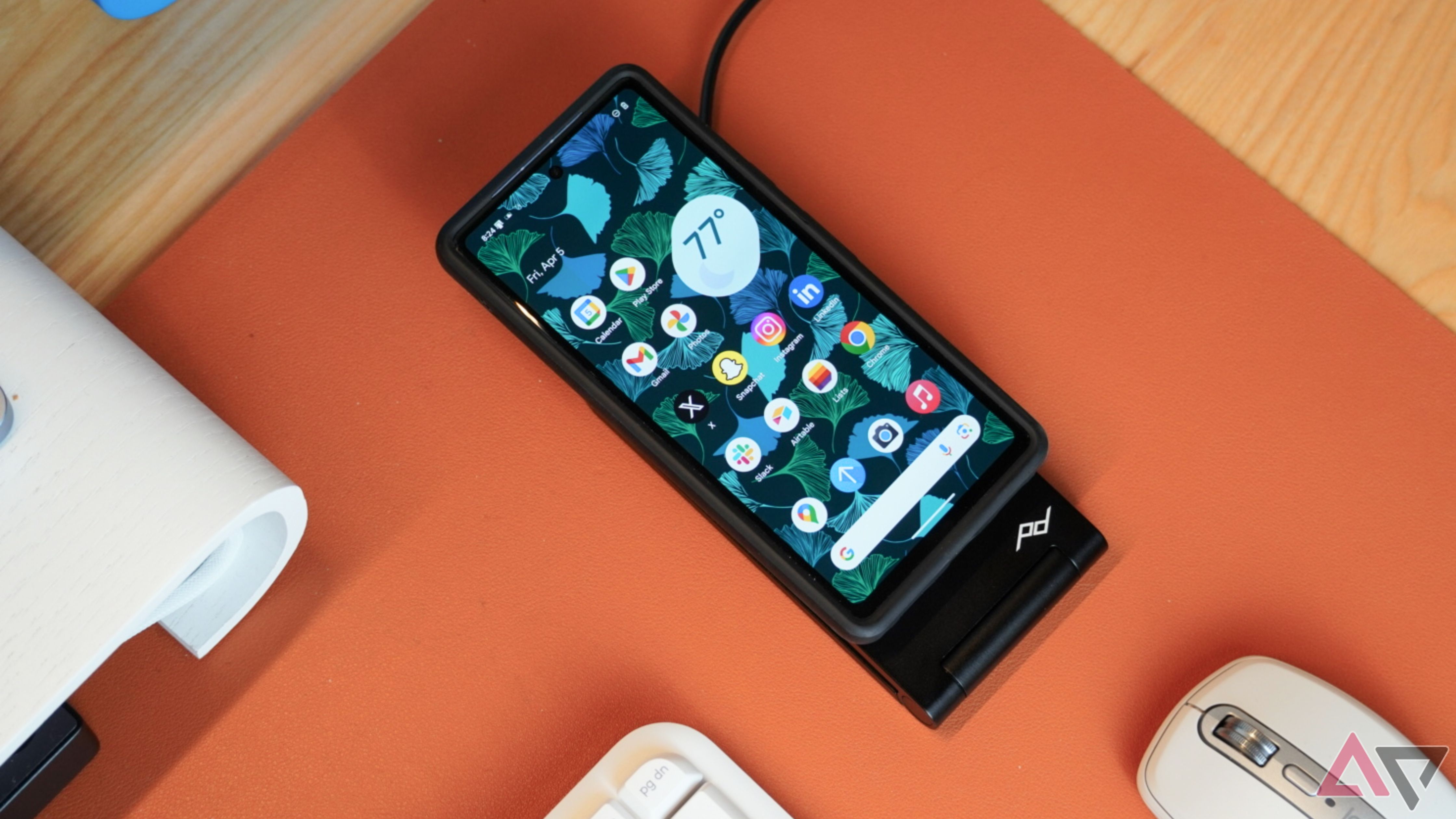 The Peak Design Qi2 wireless charging stand lying flat, charging a Pixel 7a.