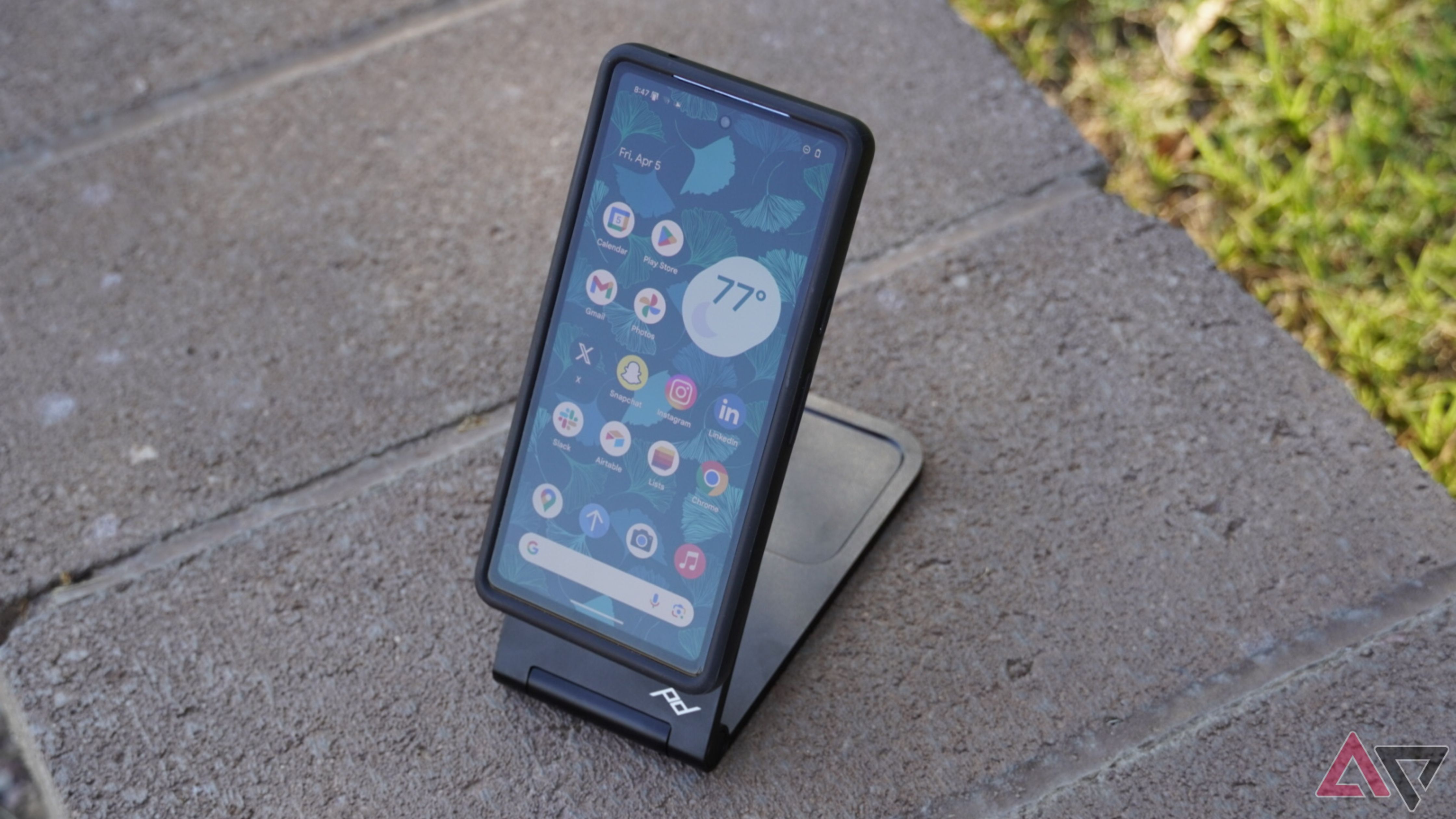 The Peak Design wireless charging stand with a Pixel 7a outdoors.