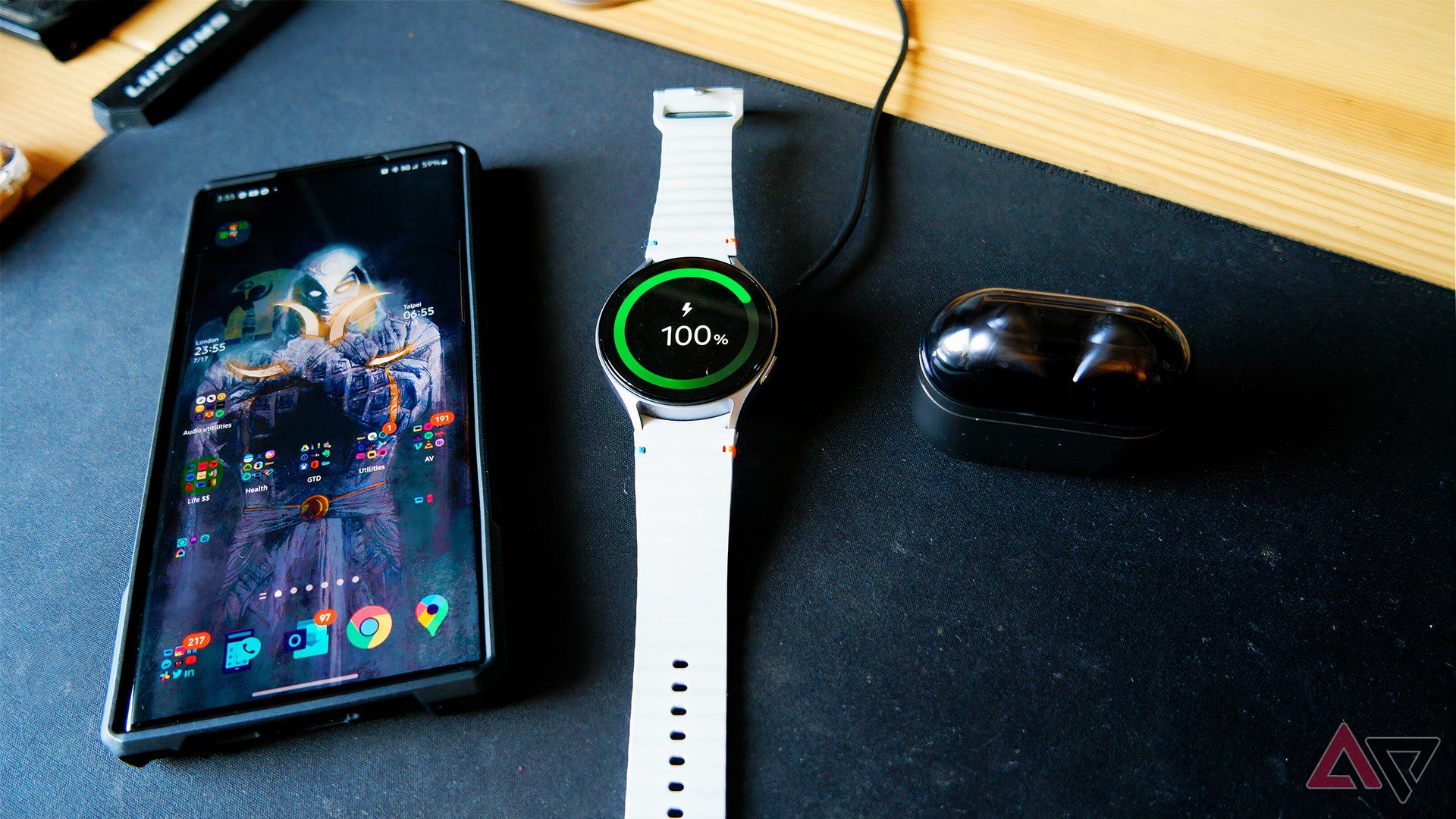 Samsung Galaxy Watch 7 on a desk with Galaxy S22 Ultra and Galaxy Buds 3 Pro