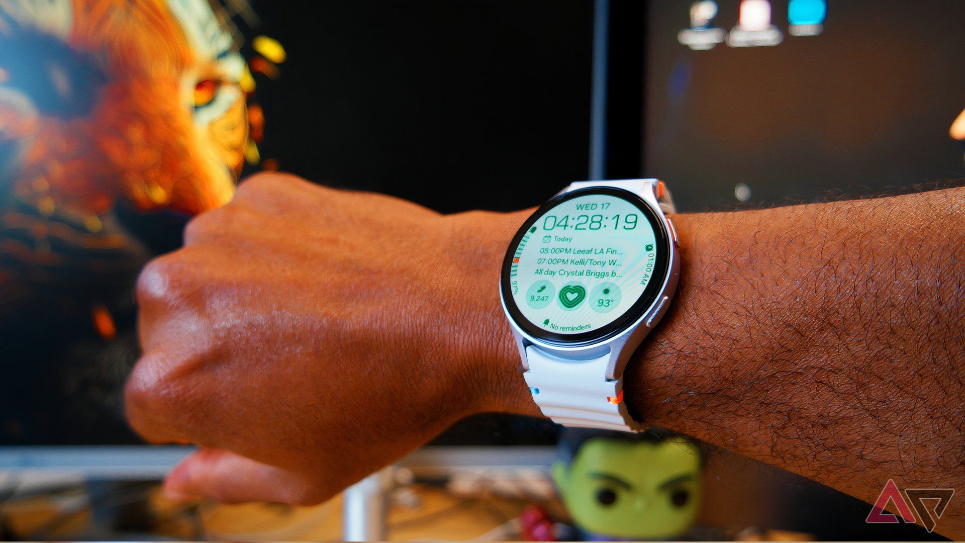 Samsung Galaxy Watch 7 in hand, showing the home screen