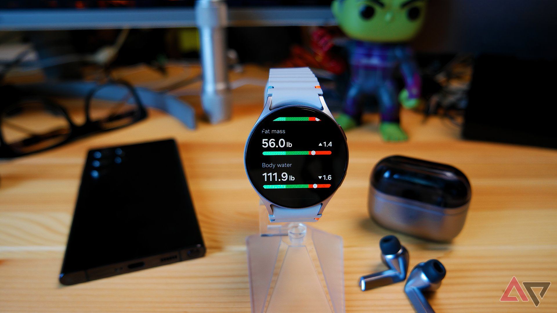 Samsung Galaxy Watch 7 on a watch stand, showing body composition stats