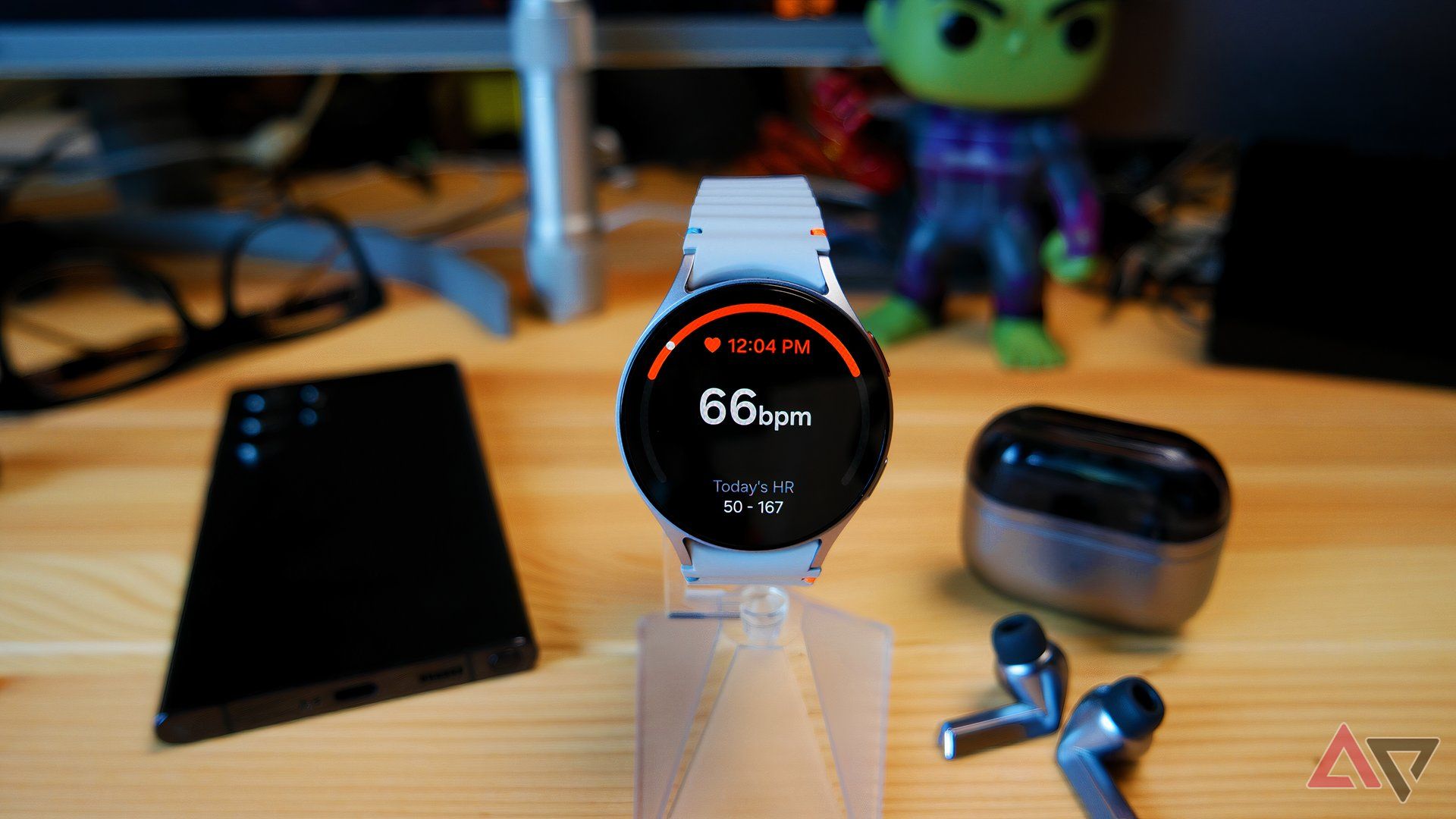 Samsung Galaxy Watch 7 on a watch stand showing heart rate