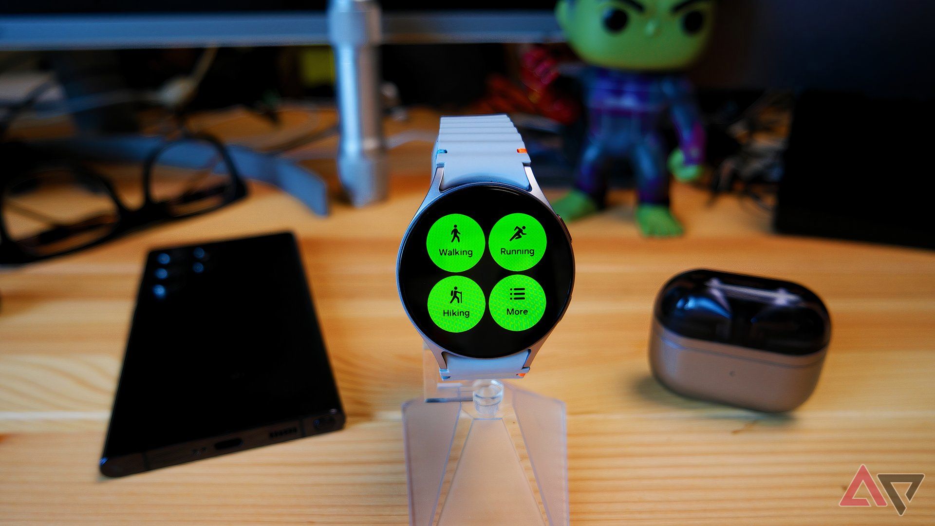 Samsung Galaxy Watch 7 on a watch stand showing the workouts screen