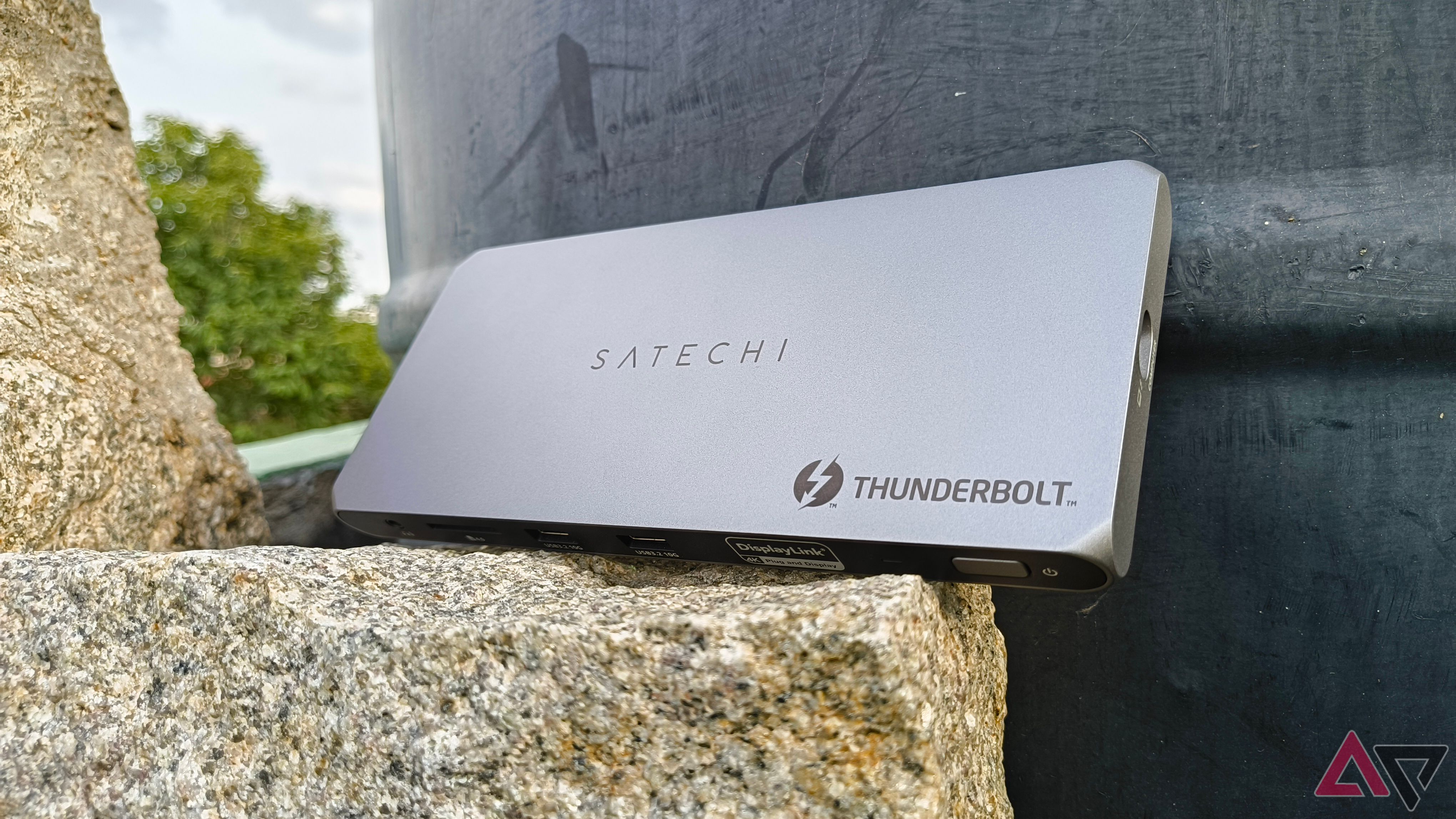 Satechi Thunderbolt 4 Dock set against a wall perched on rock