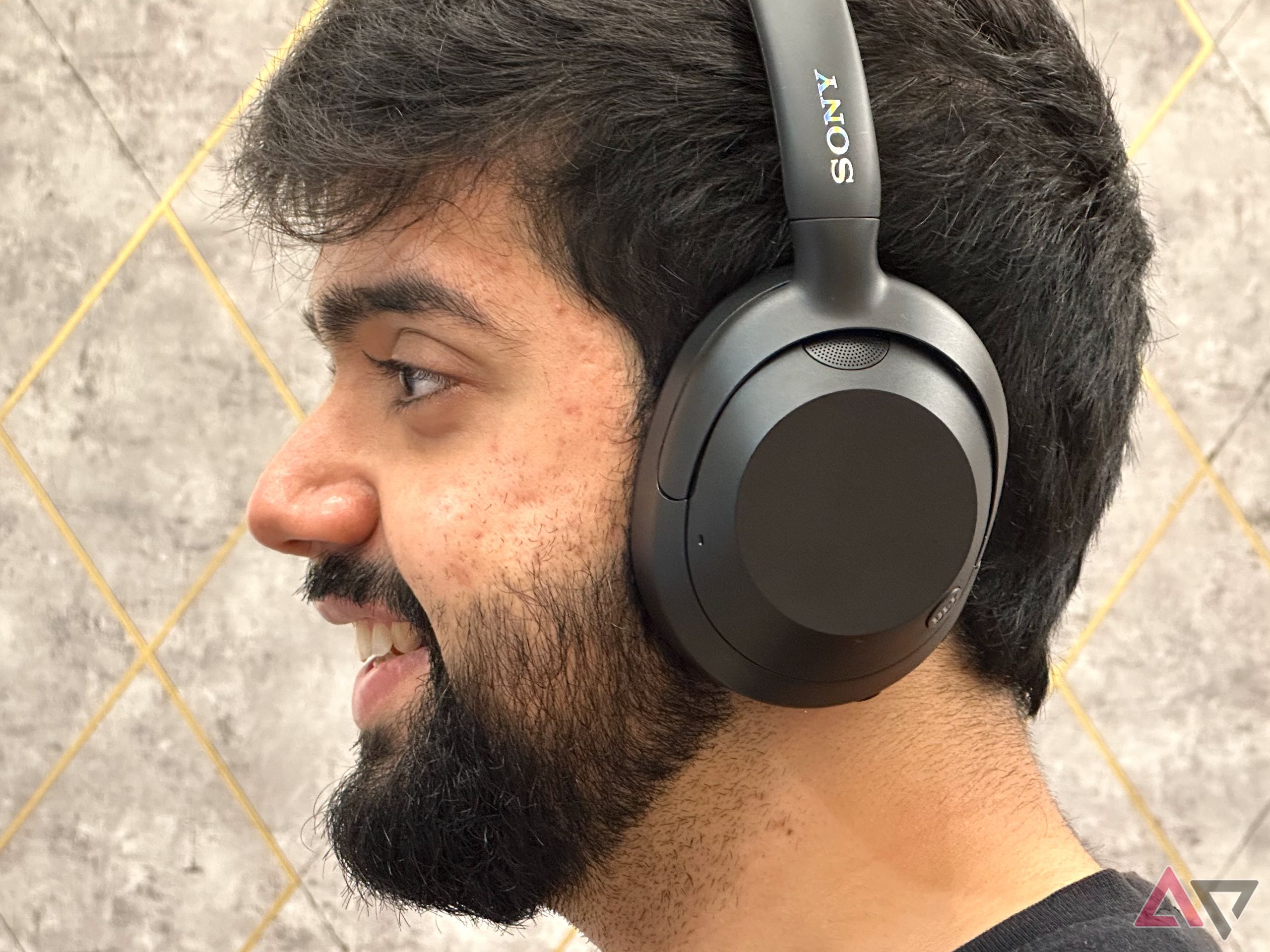 Person wearing Sony Ult Wear headphones side shot