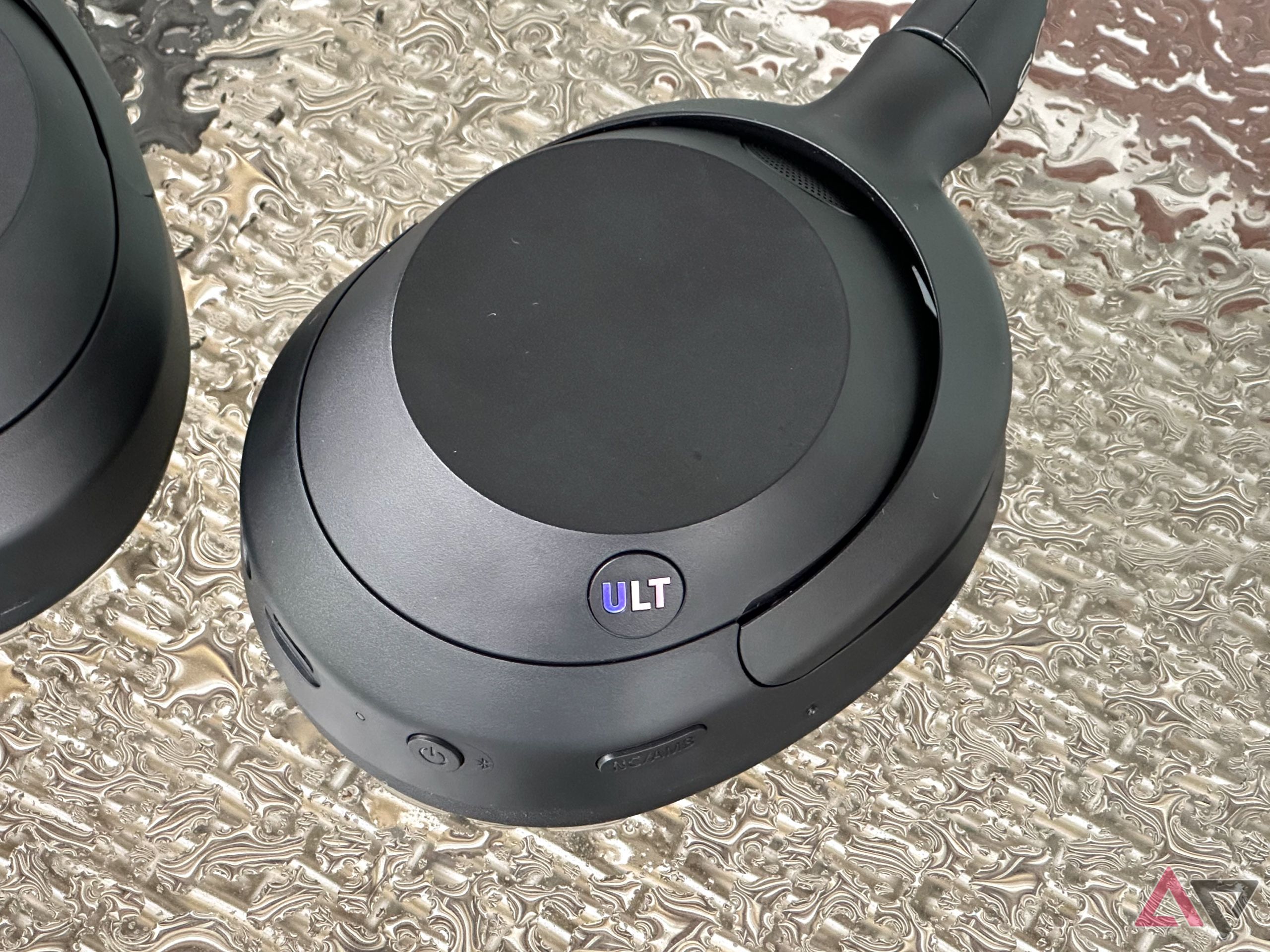 Sony Ult Wear headphones on a table with water droplets 