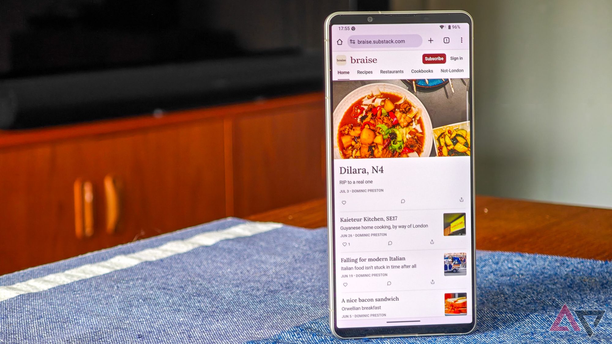 Sony-Xperia-1-VI-14-A photo of the Sony Xperia 1 VI standing on a blue tablecloth, showing the Braise Substack homepage