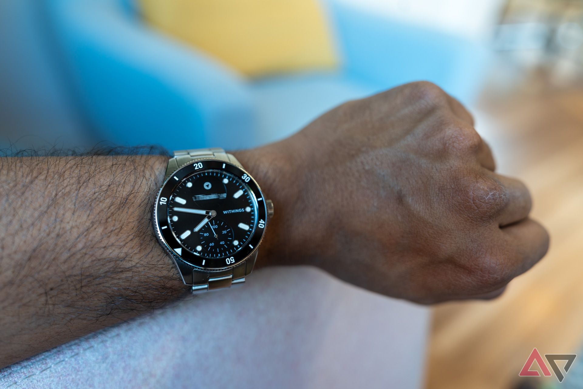 Withings ScanWatch Nova on an arm on a couch showing the watch face