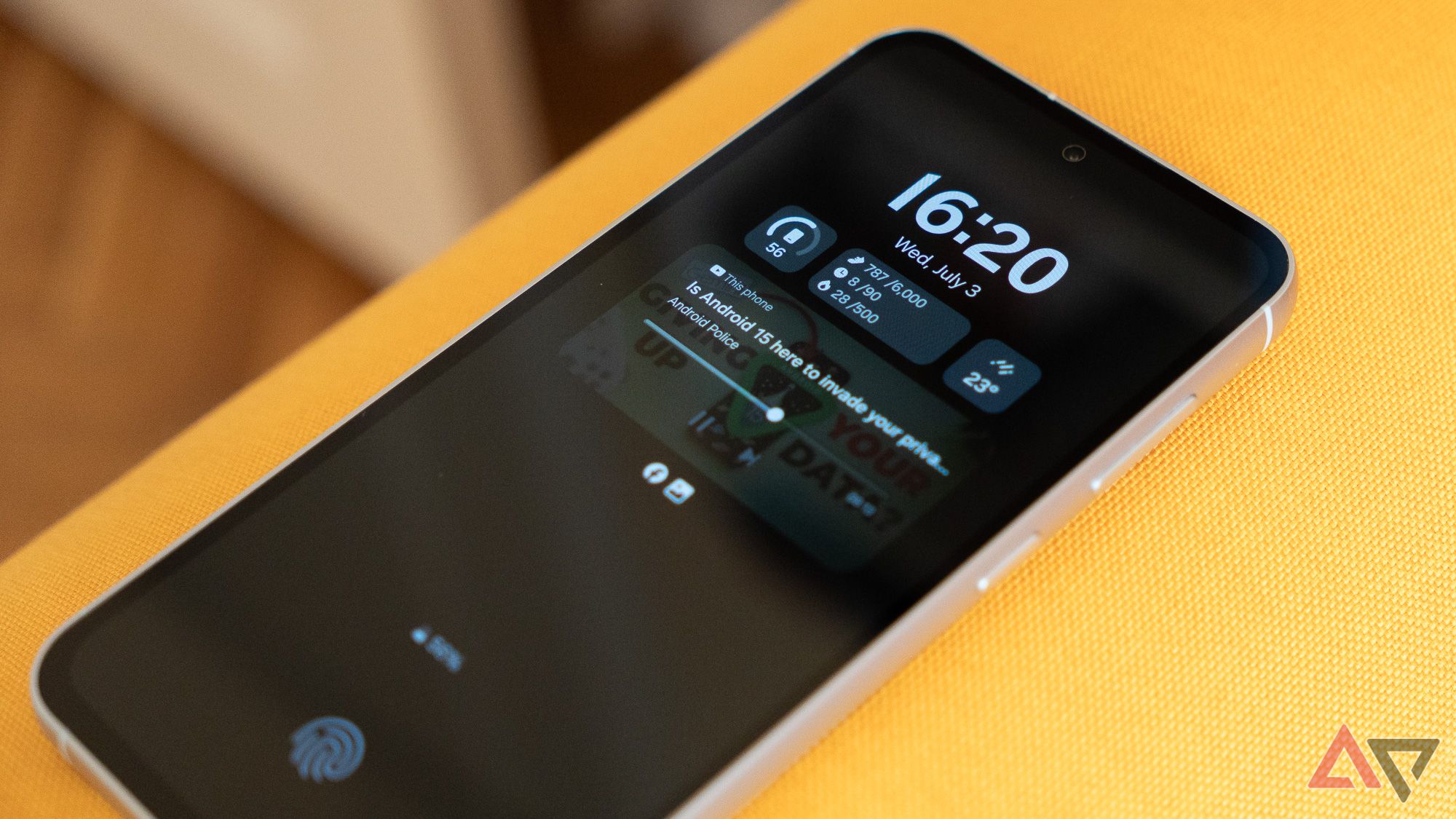 A Phone On A Yellow Couch Playing A YouTube Video With The Screen Off.