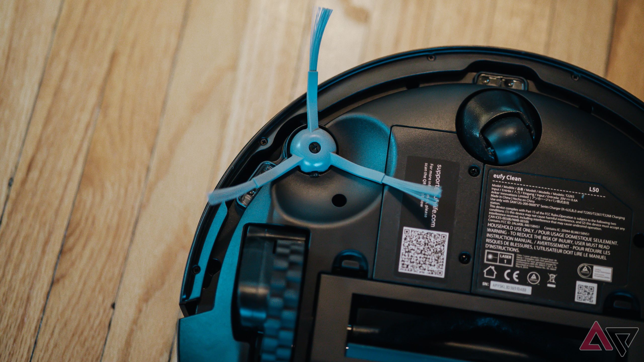 Closer view of side brush on underside of Eufy L50 robot vacuum