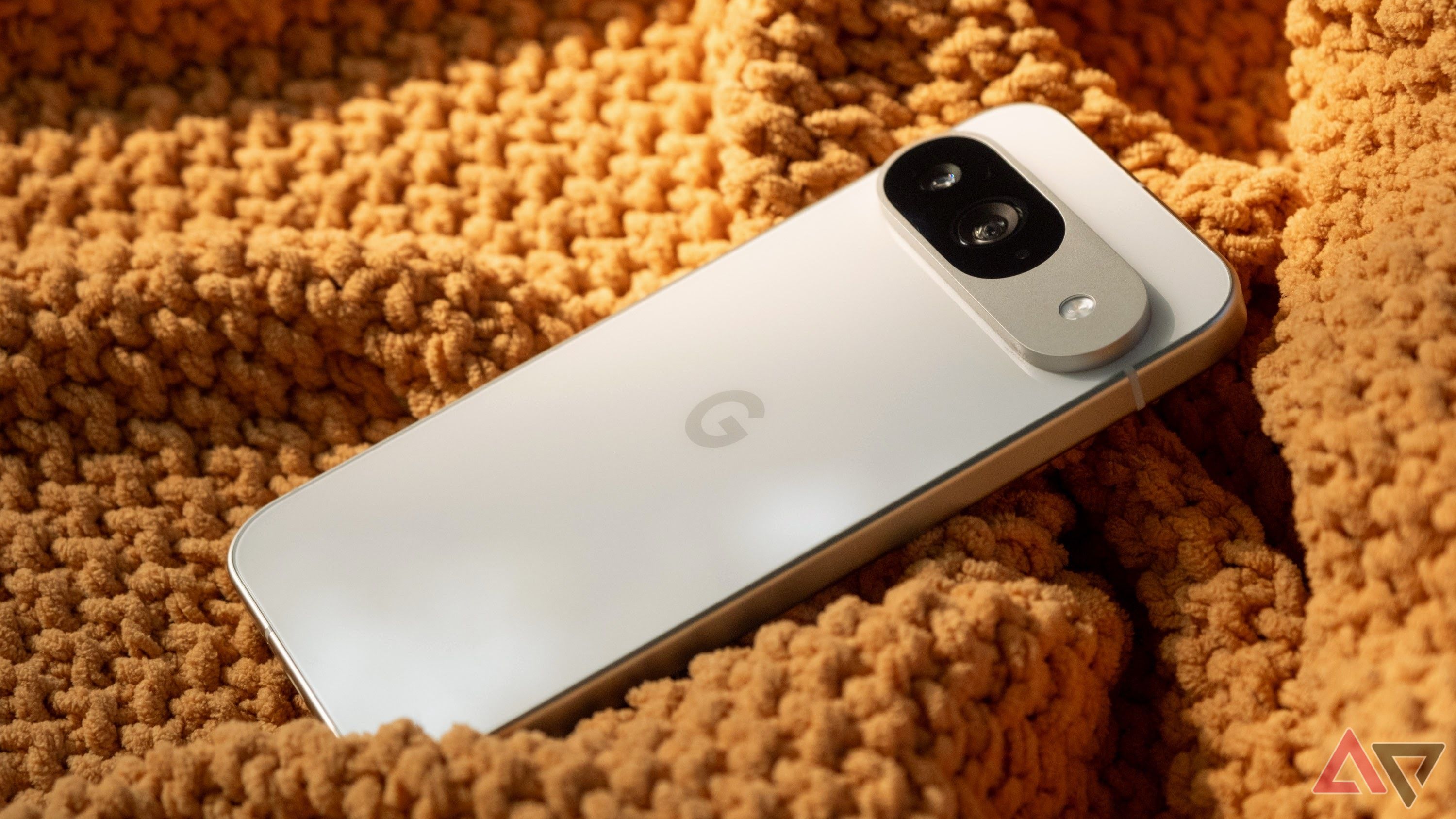 Google Pixel 9 on some orange fabric showing the rear of the phone