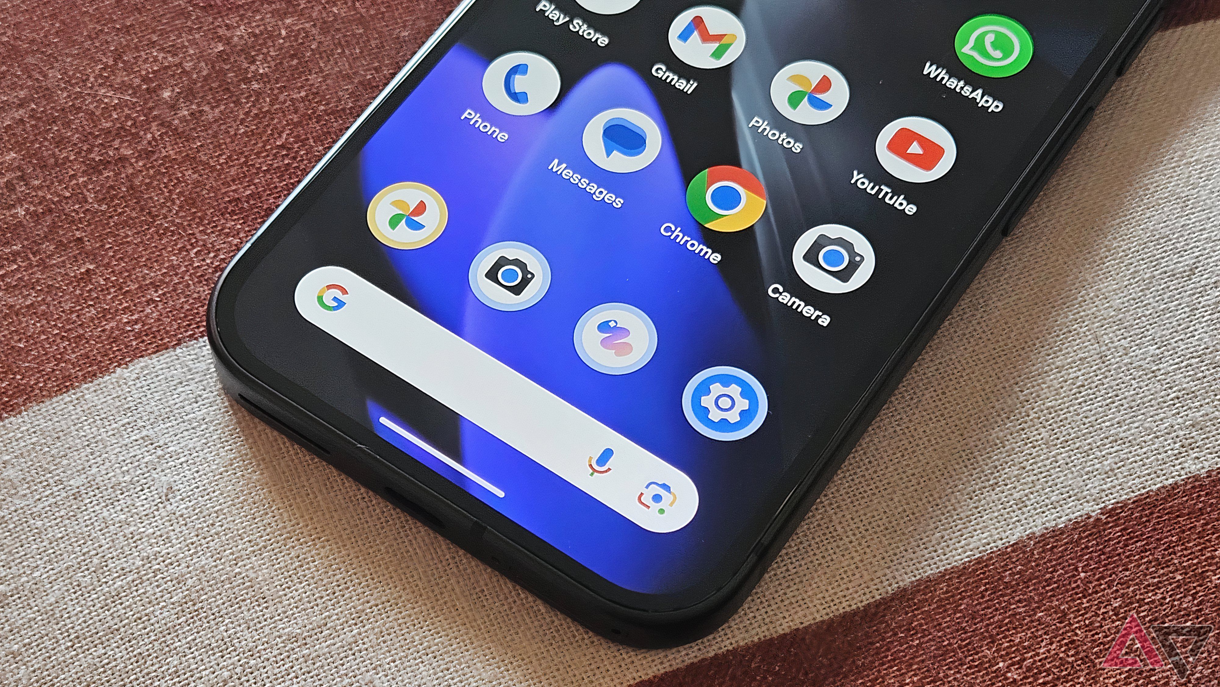 Google Pixel 9 laying on a striped blanket with screen on focused on search bar