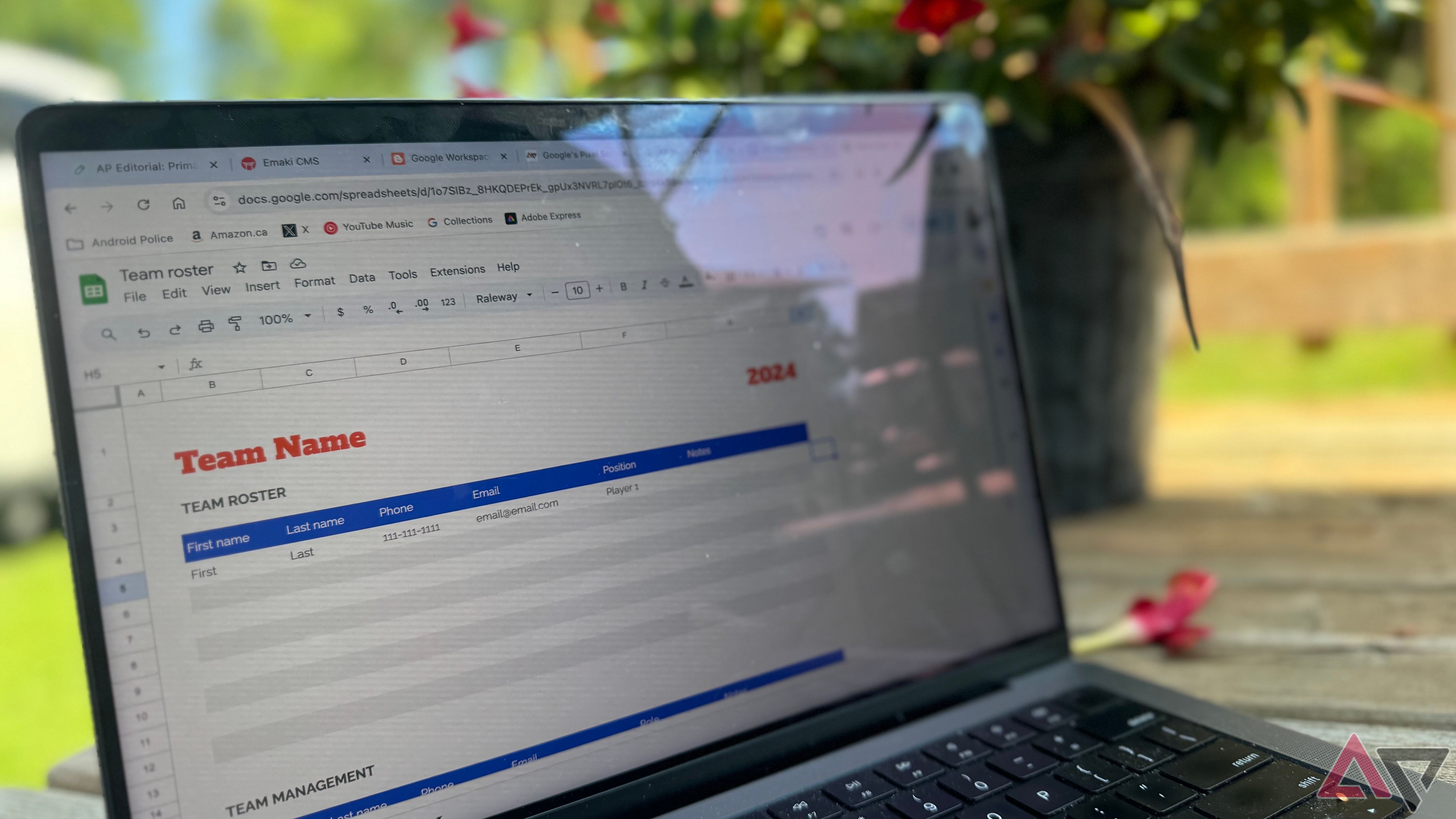 A Google Sheet with plants in the background appears on your Macbook screen